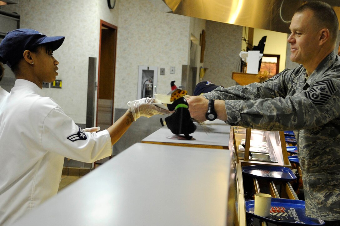 ELLSWORTH AIR FORCE BASE, S.D.-- Airman 1st Class Tiara Taylor, 28th Force Support Squadron food services journeyman, hands breakfast to Chief Master Sgt. of the Air Force James A. Roy, Oct. 22. Chief Roy ate breakfast and discussed several topics in the Air Force today with the graduating Airmen Leadership Class during the second day of his visit. (U.S. Air Force photo/Airman 1st Class Corey Hook)