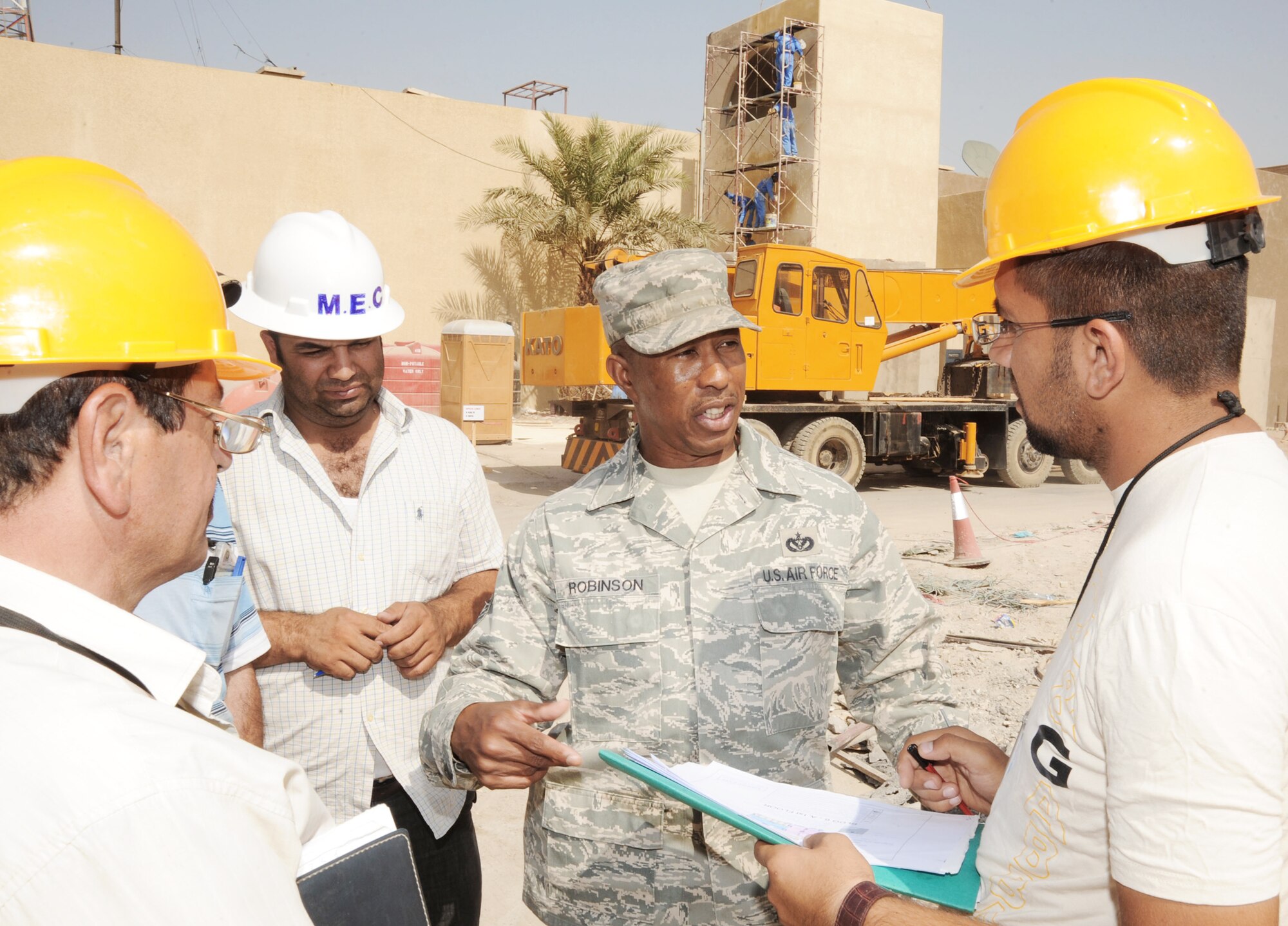 Master Sgt. Tommy Robinson coordinates with Iraqi contractors responsible for construction projects located in the International Zone Oct. 18, 2009, in Baghdad, Iraq. Sergeant Robinson is responsible for ensuring contractors follow contract agreements, safety rules and national electric codes. He is the joint area support group department of public works Team 2 NCO in charge deployed from Luke Air Force Base, Ariz. He is a native of Graceville, Fla. (U.S. Air Force photo/Tech. Sgt. Johnny L. Saldivar) 
