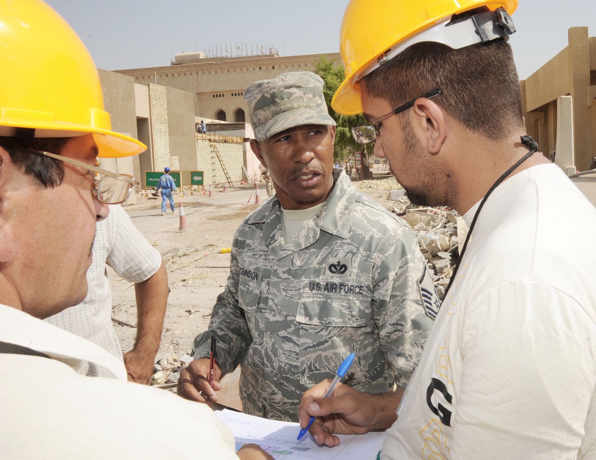 Master Sgt. Tommy Robinson coordinates with Iraqi contractors responsible for construction projects located in the International Zone Oct. 18, 2009, in Baghdad, Iraq. Sergeant Robinson is responsible for ensuring contractors follow contract agreements, safety rules and national electric codes. He is the joint area support group department of public works Team 2 NCO in charge deployed from Luke Air Force Base, Ariz. He is a native of Graceville, Fla. (U.S. Air Force photo/Tech. Sgt. Johnny L. Saldivar) 