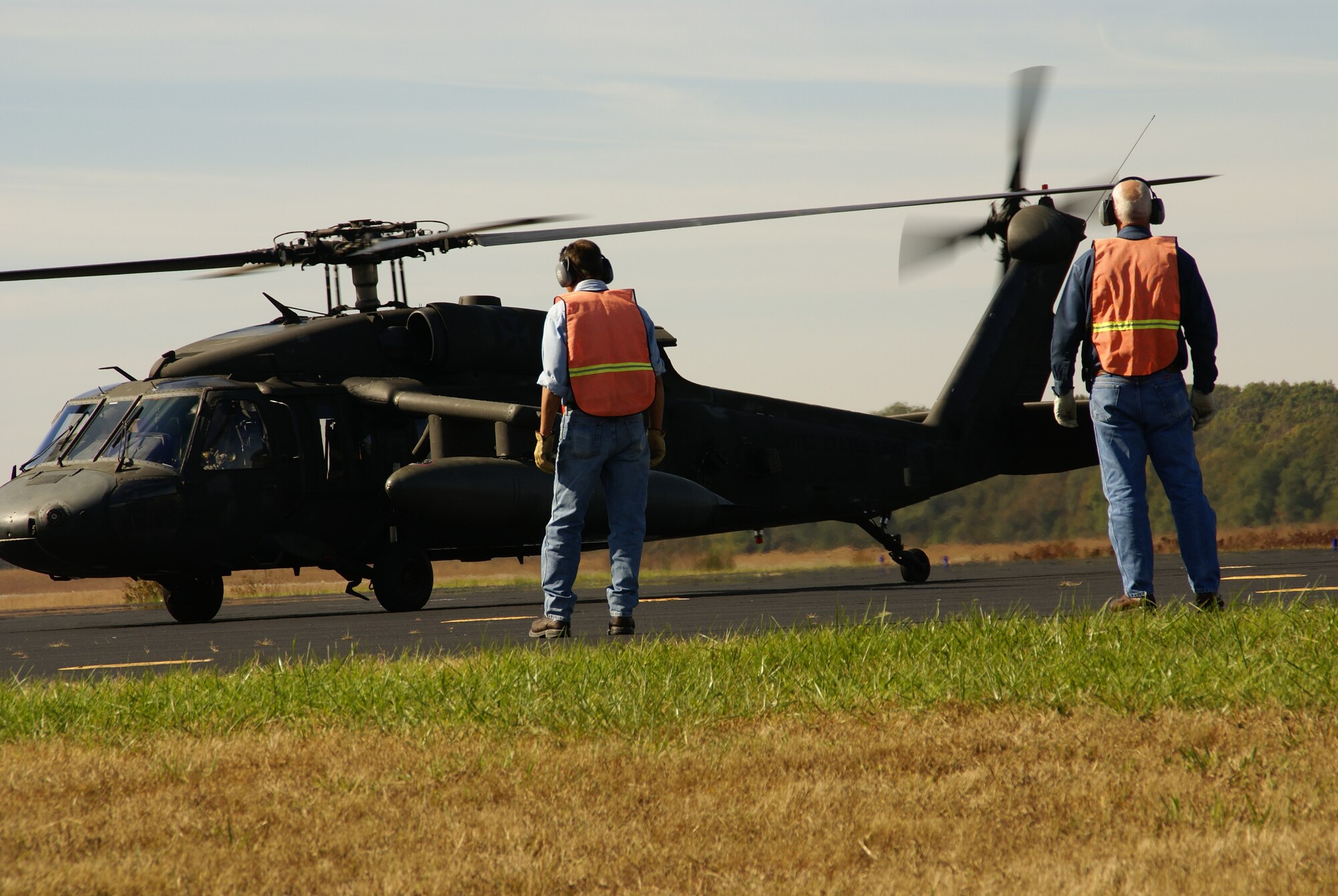 Arnold Engineering Development Center (AEDC) Fuels Specialists James Lucas and Sam McKelvey standby as the Army UH-60H Blackhawk helicopter carrying four Redstone Test and Training Center (RTTC) representatives, land at Arnold Air Force Base’s airfield Oct. 21. They were at Arnold for a site visit with AEDC leadership to discuss the possibility of conducting an undetermined amount of helicopter flight testing at Arnold’s airfield over the next few years. According to Murray King, the Flight Systems Assets Manager at Arnold, the discussions were only preliminary at this point in time. He said the RTTC is interested in AEDC as one of several outlying areas they might use as the flight test mission is moved from Fort Rucker to Redstone [Ala.] as part of a Base Realignment and Closure (BRAC) initiative. (Photo by Philip Lorenz III) 