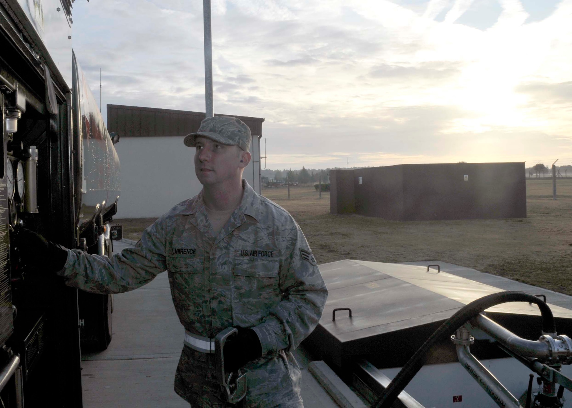 Senior Airman Lawrence Kendon, 48th Logistics Readiness Squadron fuels distribution technician, fills a truck up with fuel before heading to the flightline at RAF Lakenheath, England Oct. 13. Fuels are an essential to the mission to the base. (U.S. Air Force photo/ Airman 1st Class Eboni Knox)