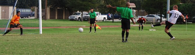 Airman 1st Class Brent Morrison, right, boots the Defender Cup winning penalty kick
recently at Lackland Air Force Base in Texas. Airman Morrison’s goal gave the Travis
Football Club, which plays locally as part of the Fairfield Adult Soccer League, the win in the annual soccer tournament. Additionally, two Travis players won individual honors (Lackland Air Force Base Public Affairs photo)