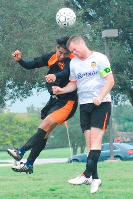 Travis’ Airman 1st Class Brendan Victory, right, takes a header against an opponent during the Defender Cup at Lackland Air Force Base. Airman Victory scored the most goals in the tournament for the second consecutive year (Lackland Air Force Base Public Affairs photo)