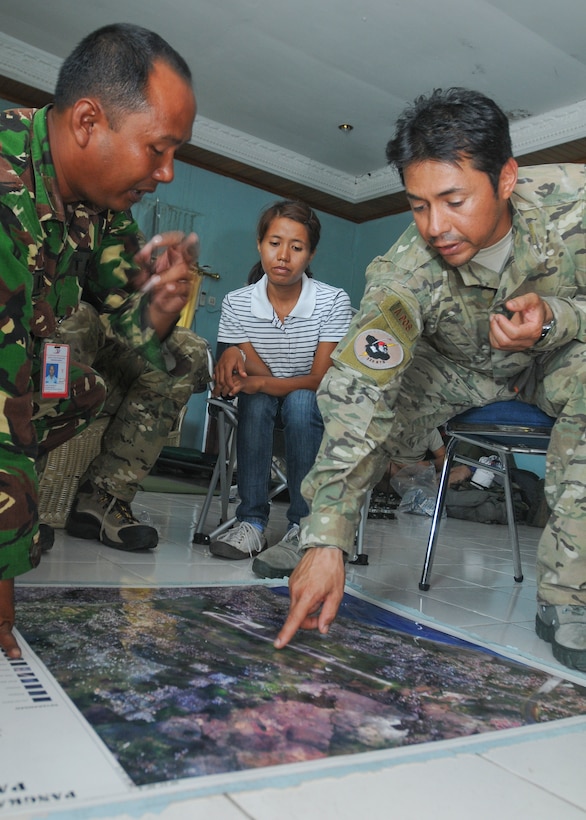 PADANG, Indonesia -- A combat controller assigned to the 353rd Special Operations Group, points out damaged aviation navigation aids during a meeting at Tabing Air Field Oct. 7. Indonesian and U.S. airmen met to discuss the restoration of aviation navigation aids to facilitate flight operations supporting humanitarian relief efforts in Padang. More than 65 members of the group provided their unique expertise in key areas to multiple organizations supporting relief efforts across the affected area. (U.S. Navy photo by Mass Communication Specialist 2nd Class Greg Johnson)
