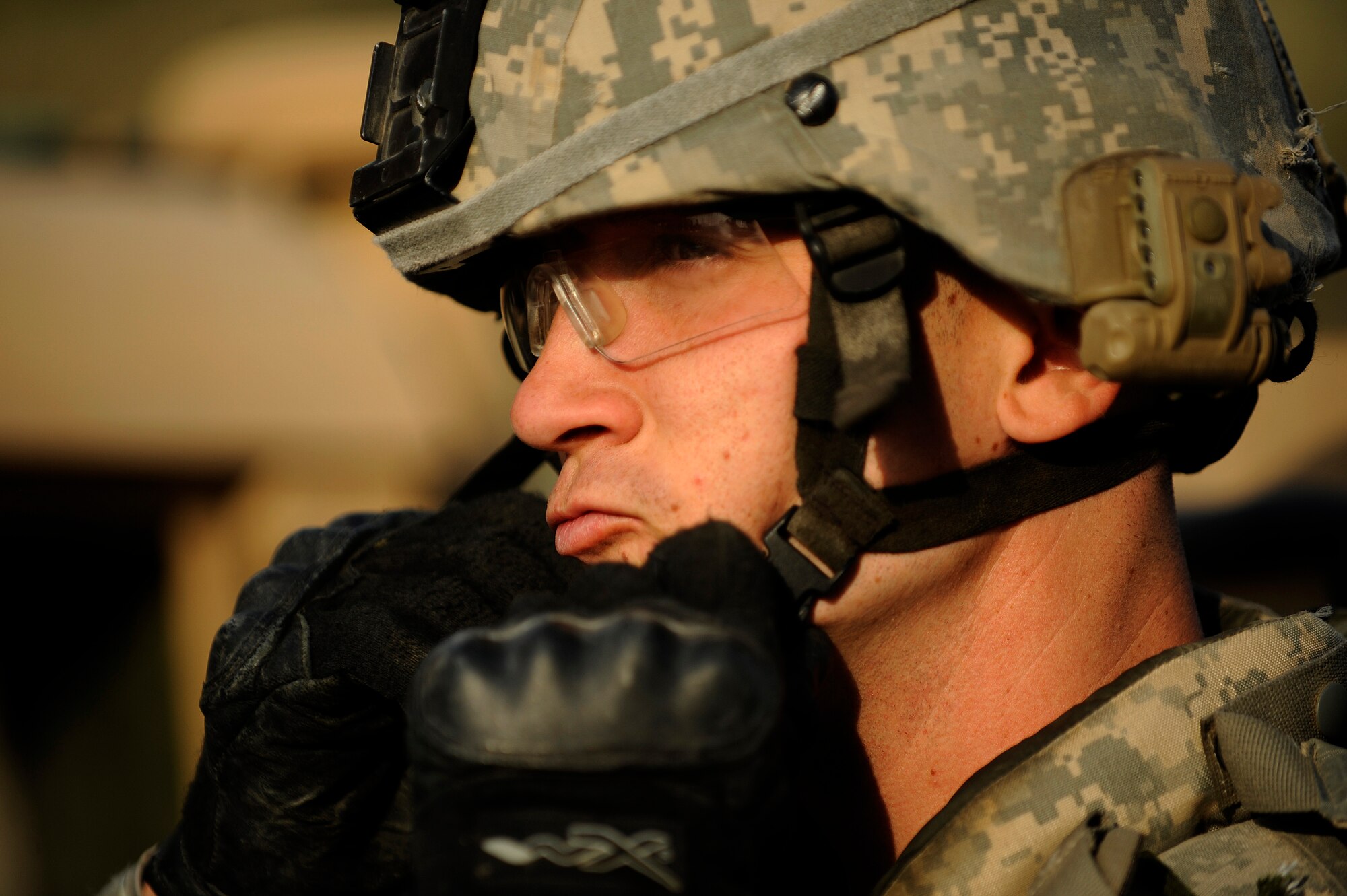 JOINT BASE BALAD, Iraq -- Staff Sgt. Justin Rush of the 532nd Expeditionary Security Forces Squadron secures his helmet prior to a force protection patrol outside the base Oct. 17, 2009. The 532nd ESFS patrols outside JBB to provide a security presence intended to deter anyone who would do harm to the people who live and work here. (U.S. Air Force photo/Staff Sgt. Michael B. Keller) 