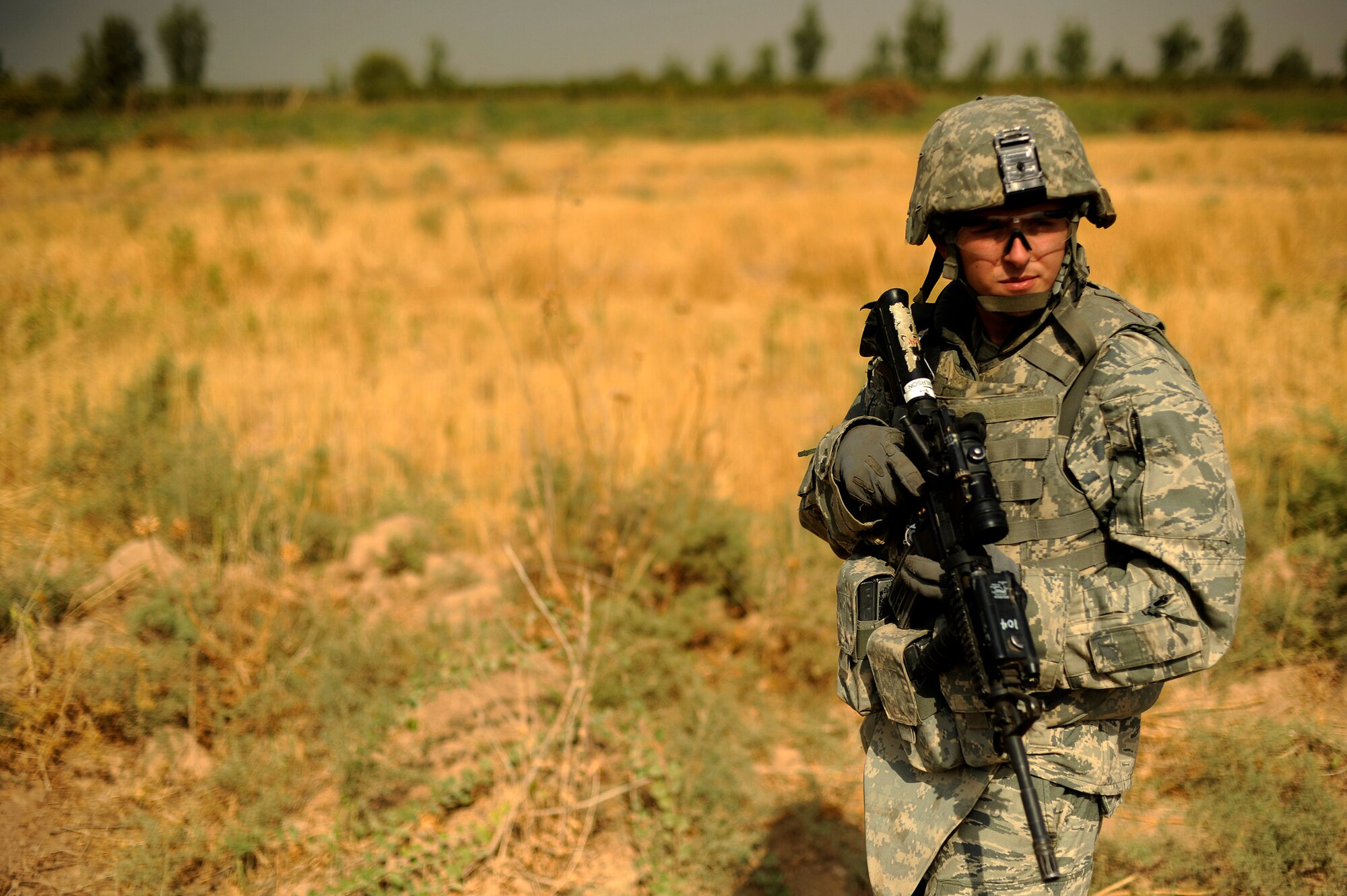 JOINT BASE BALAD, Iraq -- Senior Airman Michael Emerson of the 532nd Expeditionary Security Forces Squadron scans a field during a force protection patrol outside the base Oct. 17, 2009. The 532nd ESFS patrols outside JBB to provide a security presence intended to deter anyone who would do harm to the people who live and work here. (U.S. Air Force photo/Staff Sgt. Michael B. Keller) 