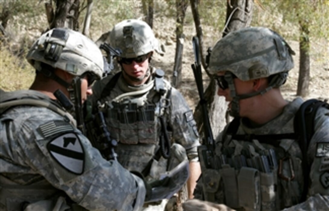 U.S. Army 1st Lt. Kevin Jewell (right) talks to his sergeants to determine the best route during a patrol near Combat Outpost Herrera, Paktiya province, Afghanistan, on Oct. 13, 2009.  Jewell is deployed with Apache Troop, 1st Squadron, 40th Cavalry Regiment.  