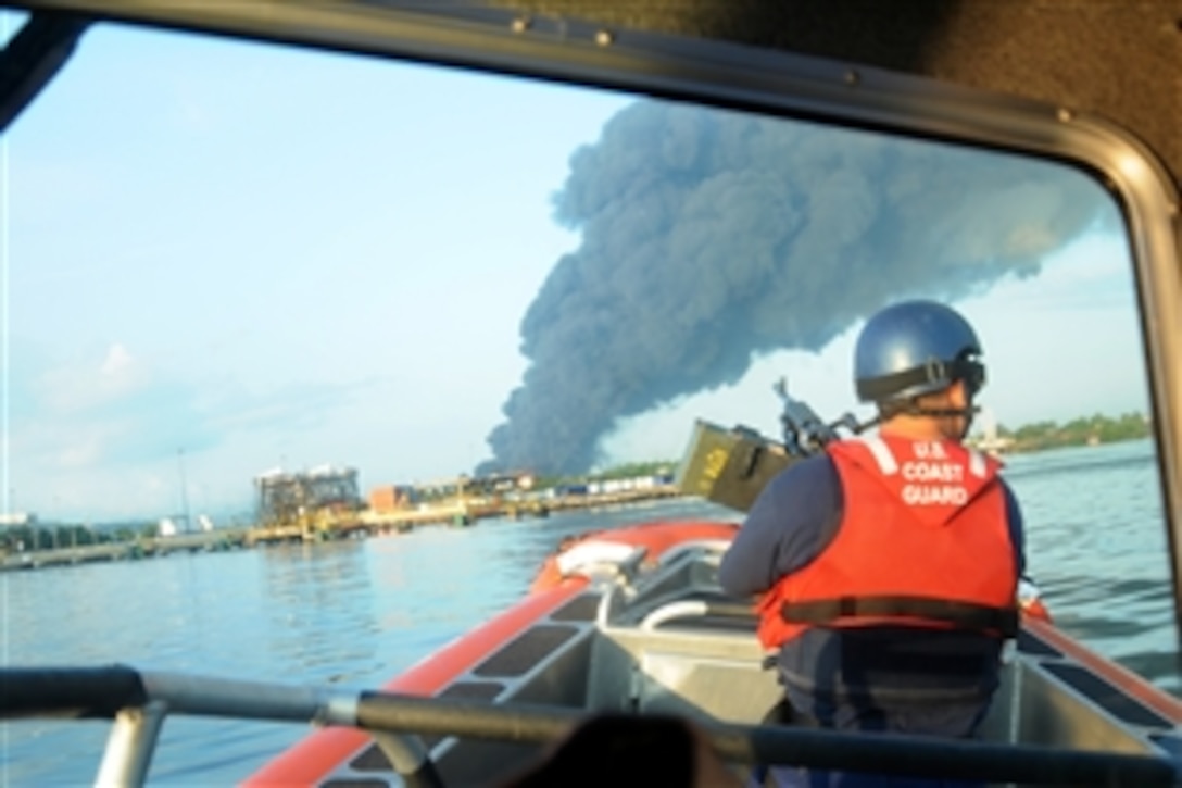 U.S. Coast Guard pollution response teams respond to an explosion at the Caribbean Petroleum Corp. tank farm in Bayamón, Puerto Rico, Oct. 23, 2009.