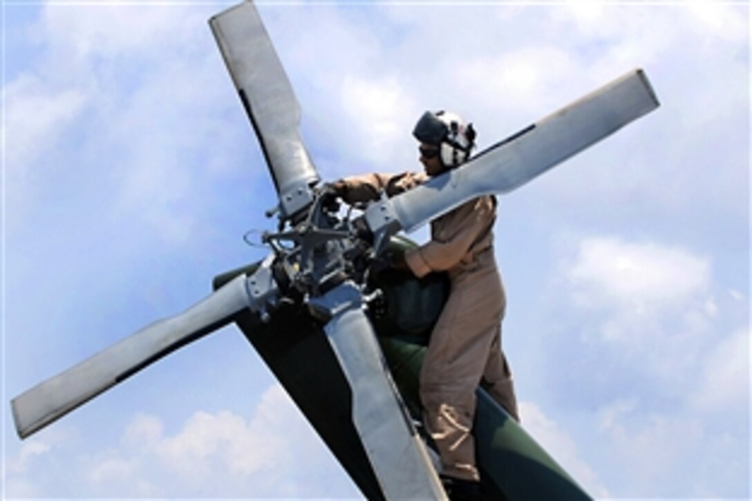 U.S. Navy Lt. Cmdr. Loren Romeus inspects the tail of an SH-60F Sea Hawk helicopter aboard the amphibious command ship USS Blue Ridge in the Pacific Ocean, Oct. 22, 2009. Blue Ridge is the flagship for Commander, U.S. 7th Fleet.