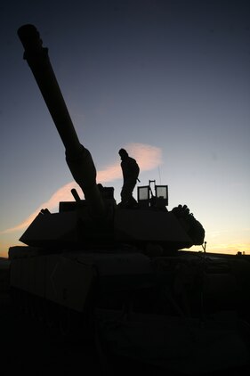 Lance Cpl. Devin Burleson, a tanker with Company D, 1st Tank Battalion, from San Angelo, Texas, inspects his tank "Iron Mike," Oct. 25. The combined arms exercise known as Steel Knight began as an exercise with tanks and was the largest ever this year with five tank companies employed.