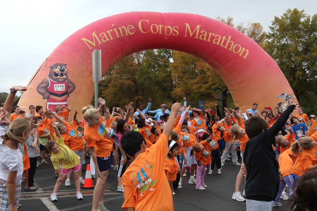 Participants in the Healthy Kids Fun Run warm up before setting off on their one-mile run in Arlington, Va., Oct. 24. About 4,000 children, ages 6 to 13, braved the cold and rain to participate in the run. The event has been a prelude to the Marine Corps Marathon for eight years.