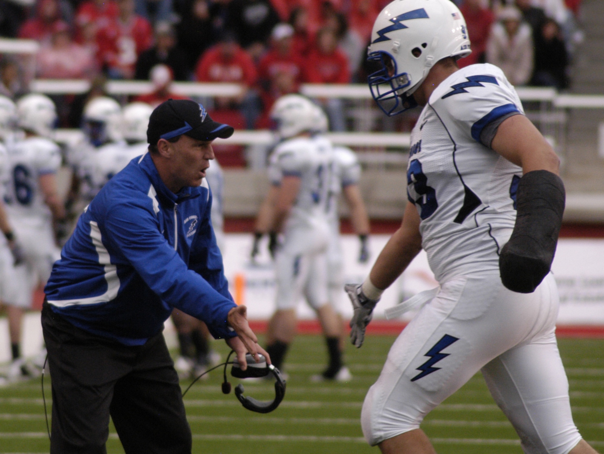 Falcons head coach Troy Calhoun, center, congratulates nose guard Ben Garland after he comes off the field following a successful first-half series during the Falcons' game against Utah in Salt Lake City Oct. 24, 2009. Air Force fell to the Utes 23-16 in overtime, dropping the Falcons to 4-4 overall and 3-2 in the Mountain West Conference. (U.S. Air Force photo/John Van Winkle)
