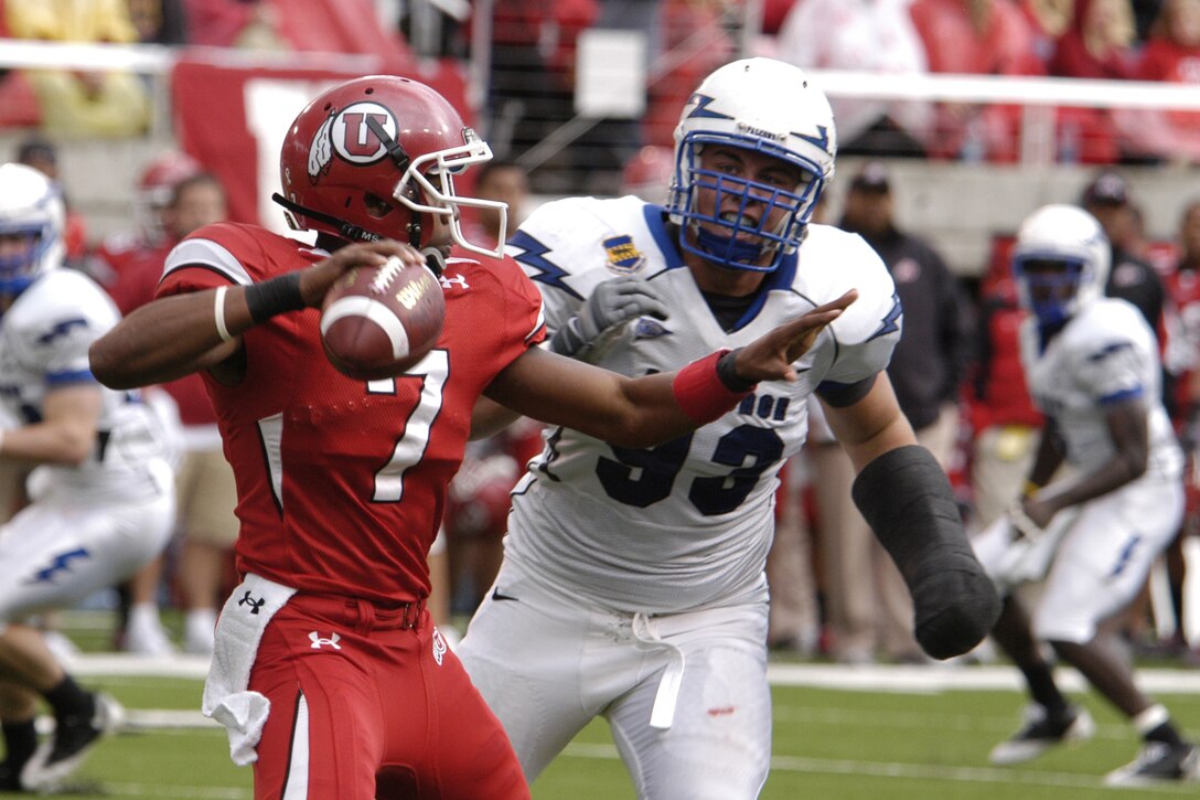 Falcons nose guard Ben Garland pressures Utah quarterback Terrance Cain during the Falcons-Utes game at Utah Oct. 24, 2009. Garland has played with a cast since breaking his arm in August. (U.S. Air Force photo/John Van Winkle)