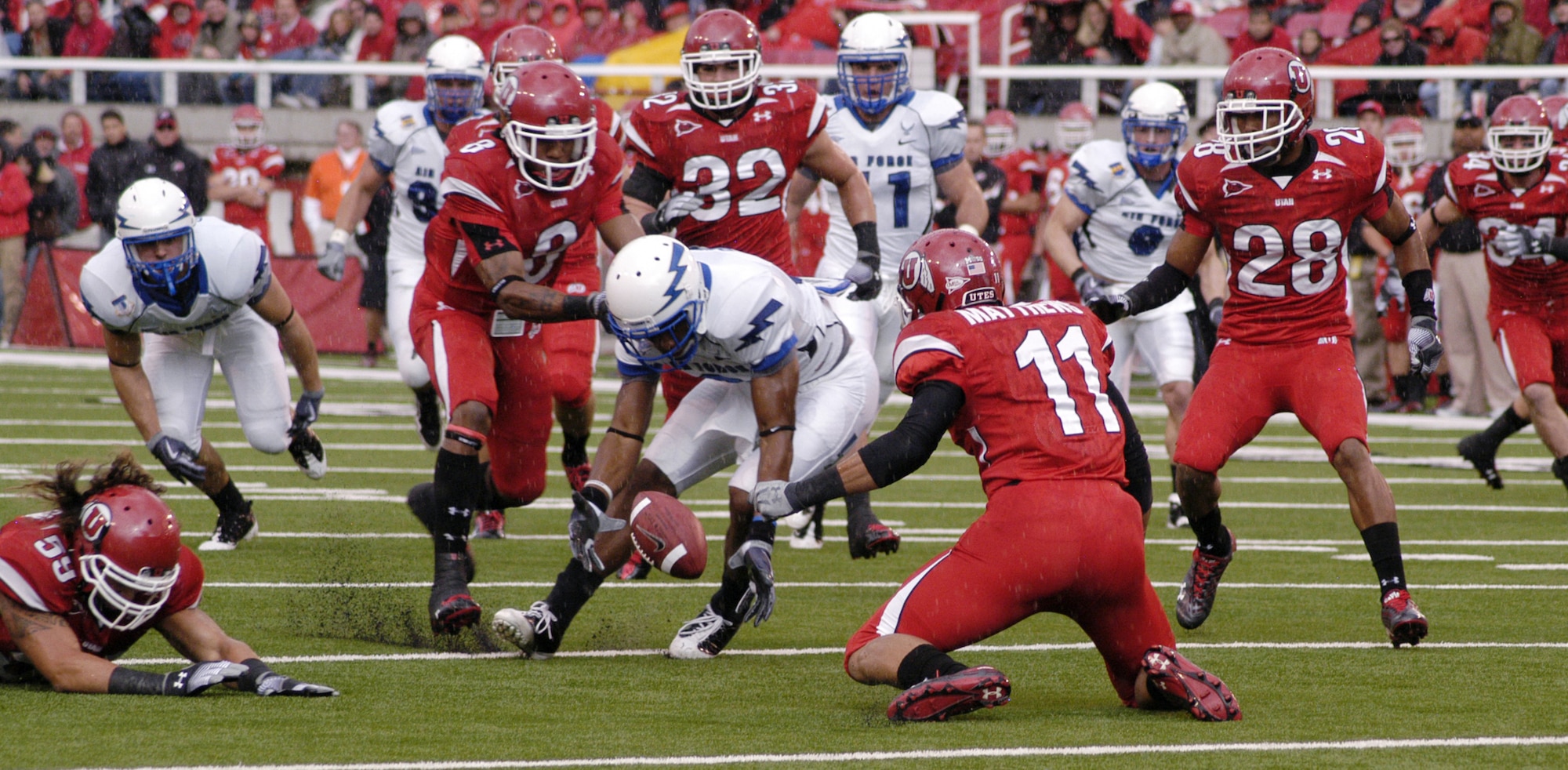 Falcon defensive back Jon Davis reaches for the ball after Utah punt returner Luke Matthews fumbled the wet ball. Davis' fumble recovery on the Utah 11-yard line led to the Falcons' first touchdown and gave the Falcons a 10-6 lead. (U.S. Air Force photo/John Van Winkle)