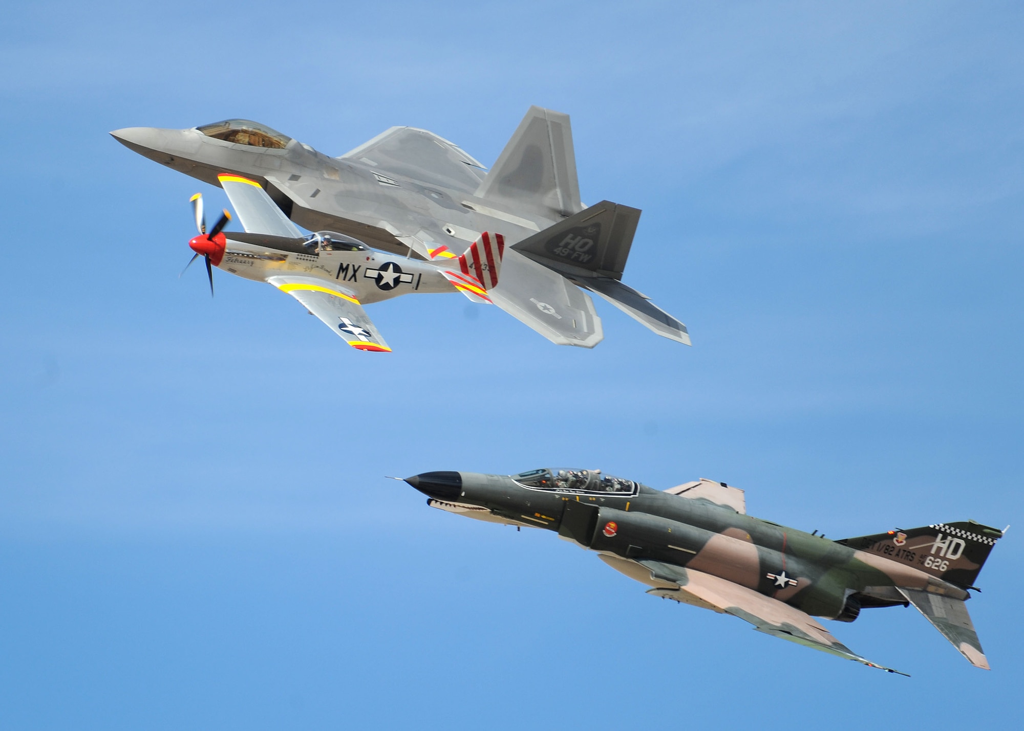 HOLLOMAN AIR FORCE BASE, N.M. -- An F-22A Raptor, P-51 Mustang and F-4 Phantom II performs a Heritage Pass here during the 2009 open house Oct. 23. The Heritage Pass concluded the aerial demonstrations of the open house. (U.S. Air Force photo by Senior Airman Michael Means)