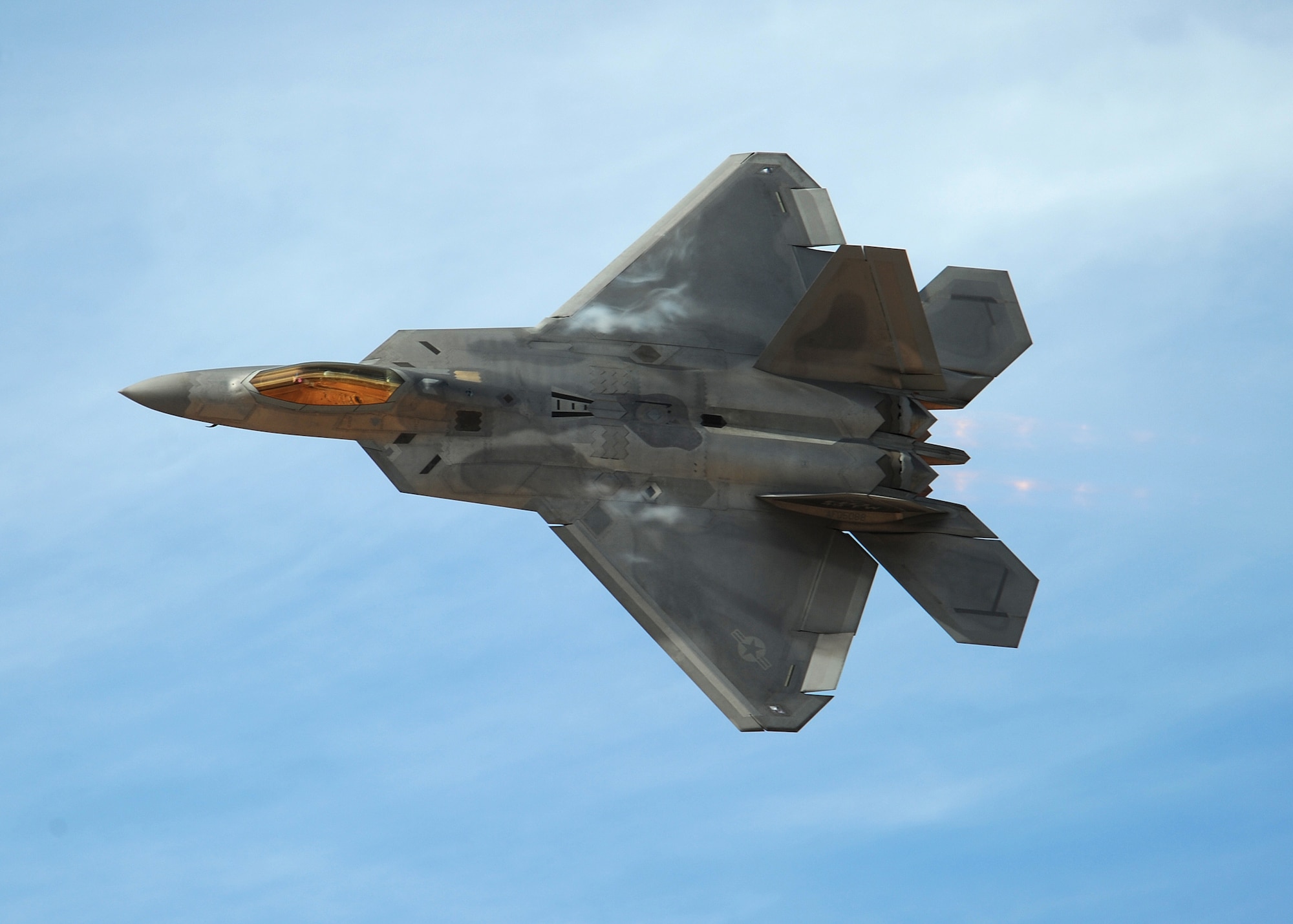 HOLLOMAN AIR FORCE BASE, N.M. ? The F-22A demonstration team performs during the 2009 open house here Oct. 24. The team, based at Langley Air Force Base, Va., performed with Holloman F-22?s. The open house featured both military and civilian aircraft, all three New Mexico bases and all branches of the military. (U.S. Air Force photo by Senior Airman Michael Means)