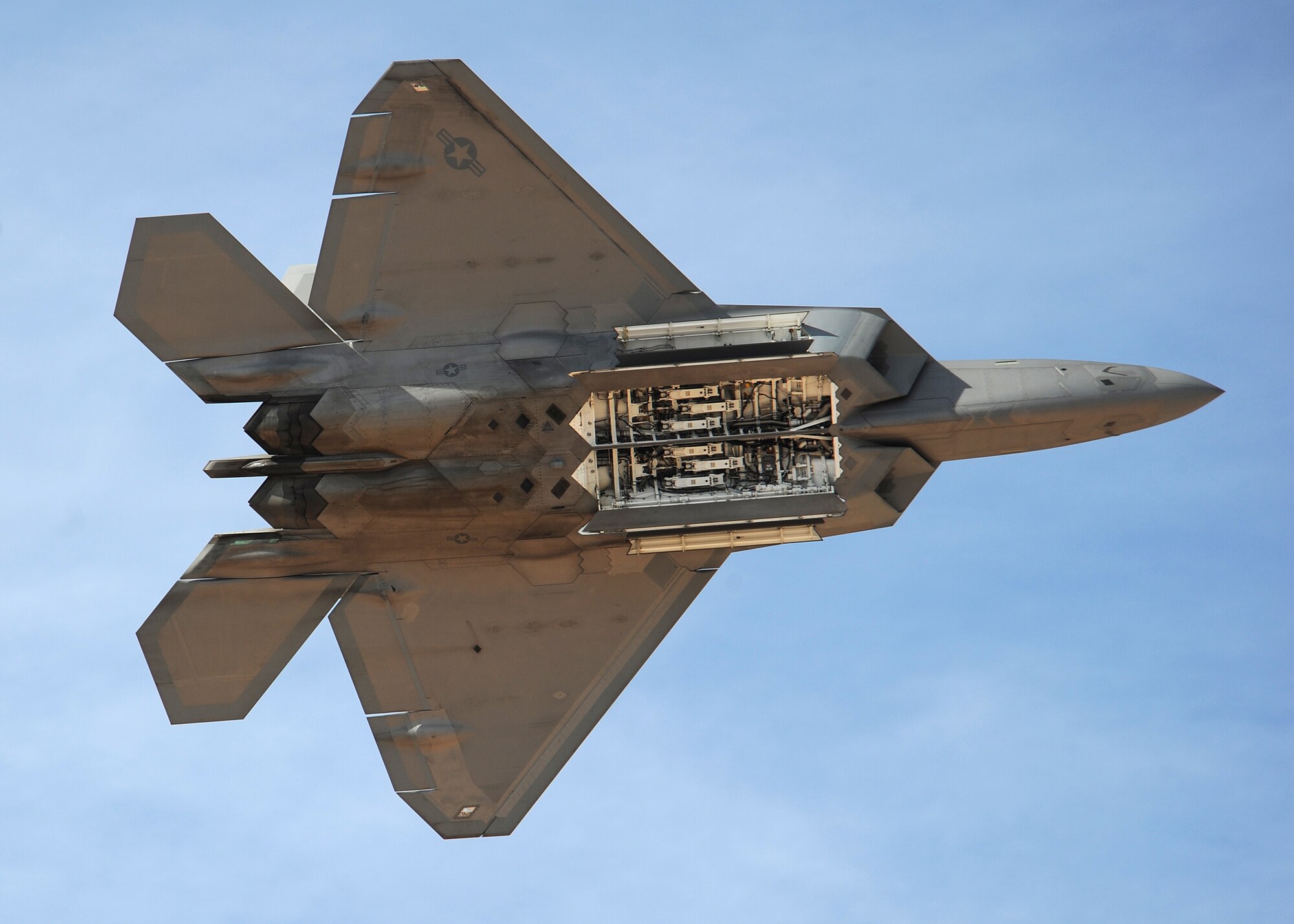 HOLLOMAN AIR FORCE BASE, N.M. ? The F-22A demonstration team performs during the 2009 open house here Oct. 24. The team, based at Langley Air Force Base, Va., performed with Holloman F-22?s. The open house featured both military and civilian aircraft, all three New Mexico bases and all branches of the military. (U.S. Air Force photo by Senior Airman Michael Means)
