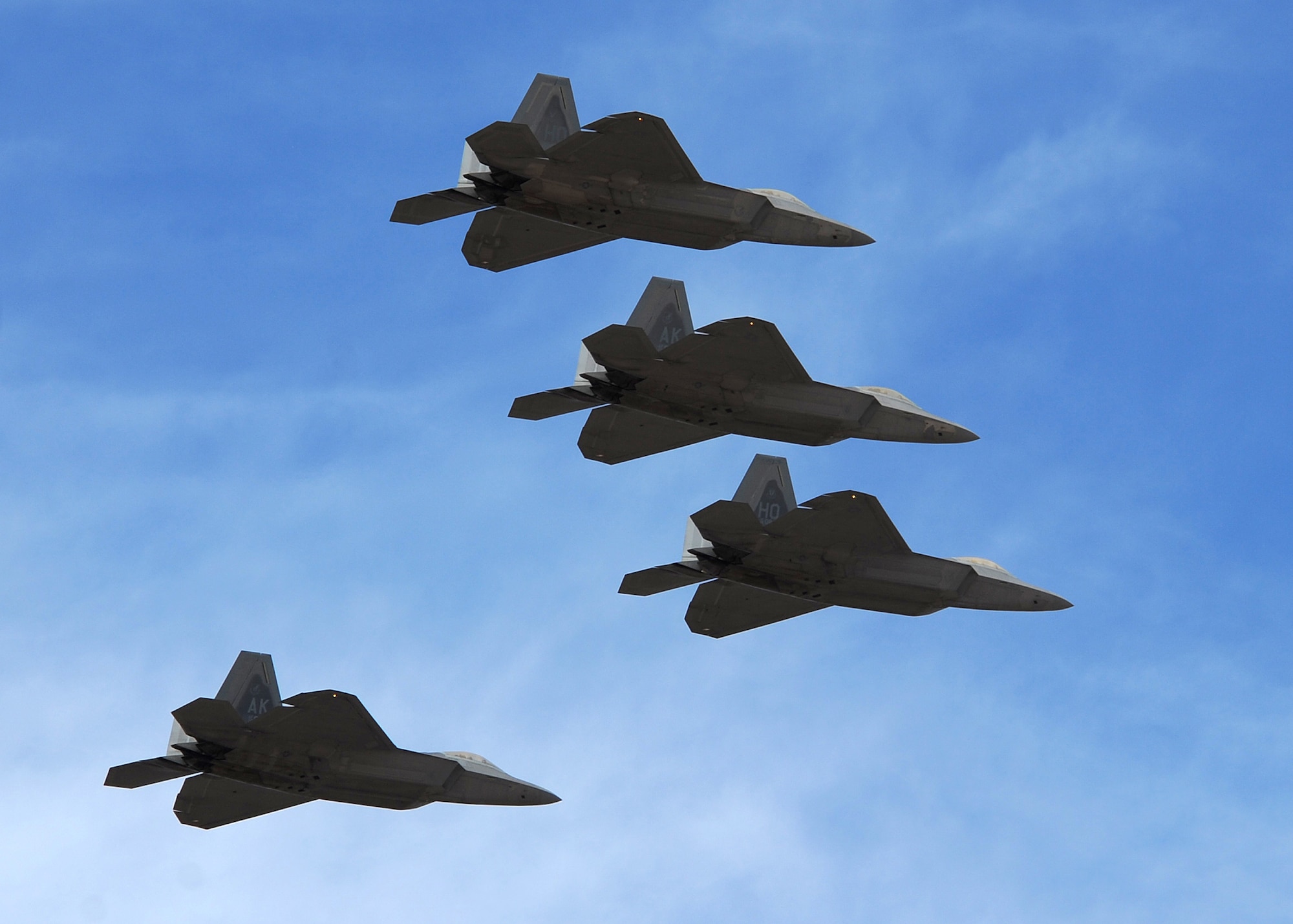 HOLLOMAN AIR FORCE BASE, N.M. -- A four ship of F-22A Raptors performs a flyby over the 2009 open house here Oct. 24. This F-22 flyby was one of many including the T-38 Talon, MQ-9 Reaper, C-17 Globemaster III and German air force Tornado. The open house also featured both military and civilian acts as well as static displays of a variety of aircraft. (U.S. Air Force photo by Senior Airman Michael Means)