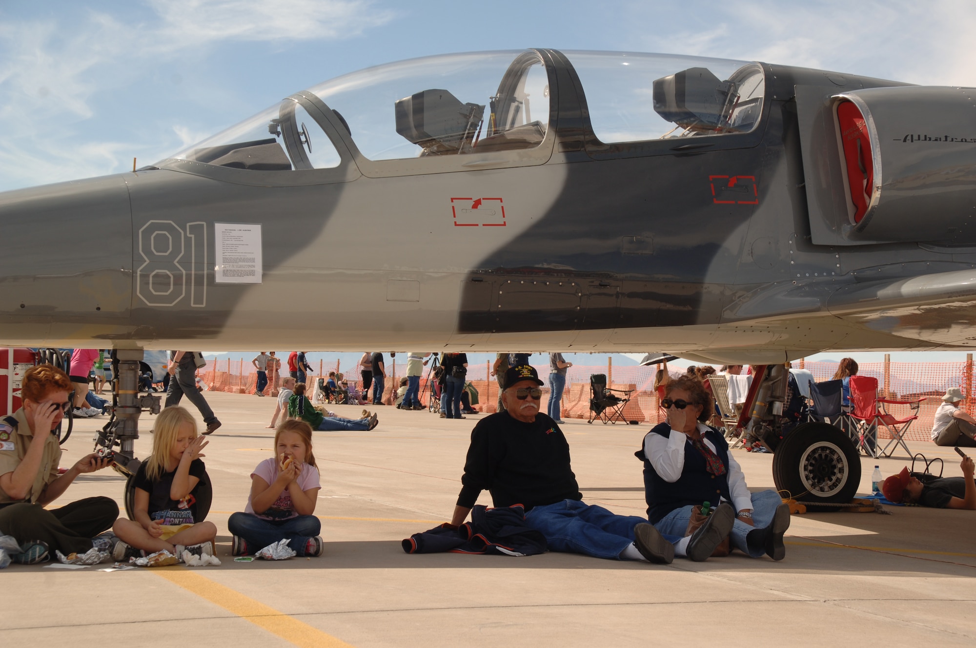 HOLLOMAN AIR FORCE BASE, N.M. -- Holloman Open House patrons take a break from the show, and the sun, under a T-38 Talon at the 2009 open house here Oct. 24. The Holloman Open House showcased military and civilian aircraft. (U.S. Air Force photo by Staff Sgt. Sanjay Allen)

