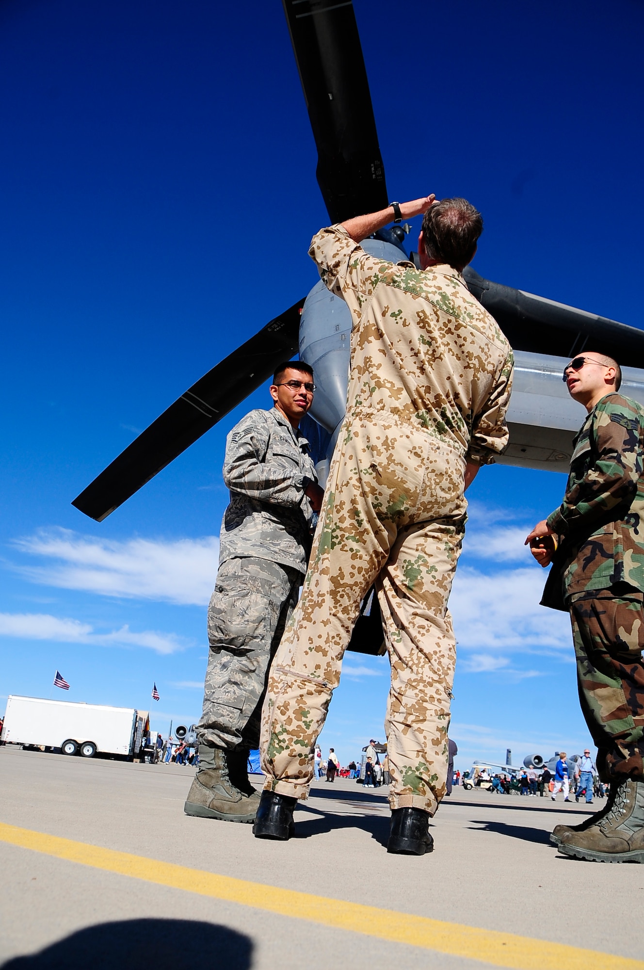 HOLLOMAN AIR FORCE BASE, N.M. -- Airmen from the U.S. and German Air Forces watch the 2009 open house from under the engine of a CV-22 Osprey. The Holloman Open House showcased military and civilian aircraft. (U.S. Air Force photo by Tech. Sgt. Chris Flahive)
