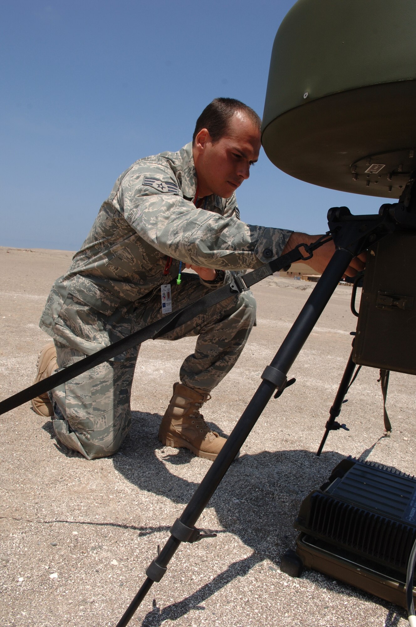 IQUIQUE, Chile -- Senior Airman Nelson Santiago, 23rd Special Tactics Squadron airfield systems technician, performs an hourly check on a portable tactical navigation aid (TACAN) during SALITRE, a Chilean-led multinational exercise focused on interoperability between Chile, the United States, France, Argentina and Brazil. The TACAN allows U.S. F-15 pilots to locate the two operating airfields involved in SALITRE, and orient themselves for landing. The TACAN is typically used by combat controllers to establish airfields in austere environments, and this is the first time the 23rd STS has used them in an exercise of this nature. (U.S. Air Force photo by Tech. Sgt. Eric Petosky)