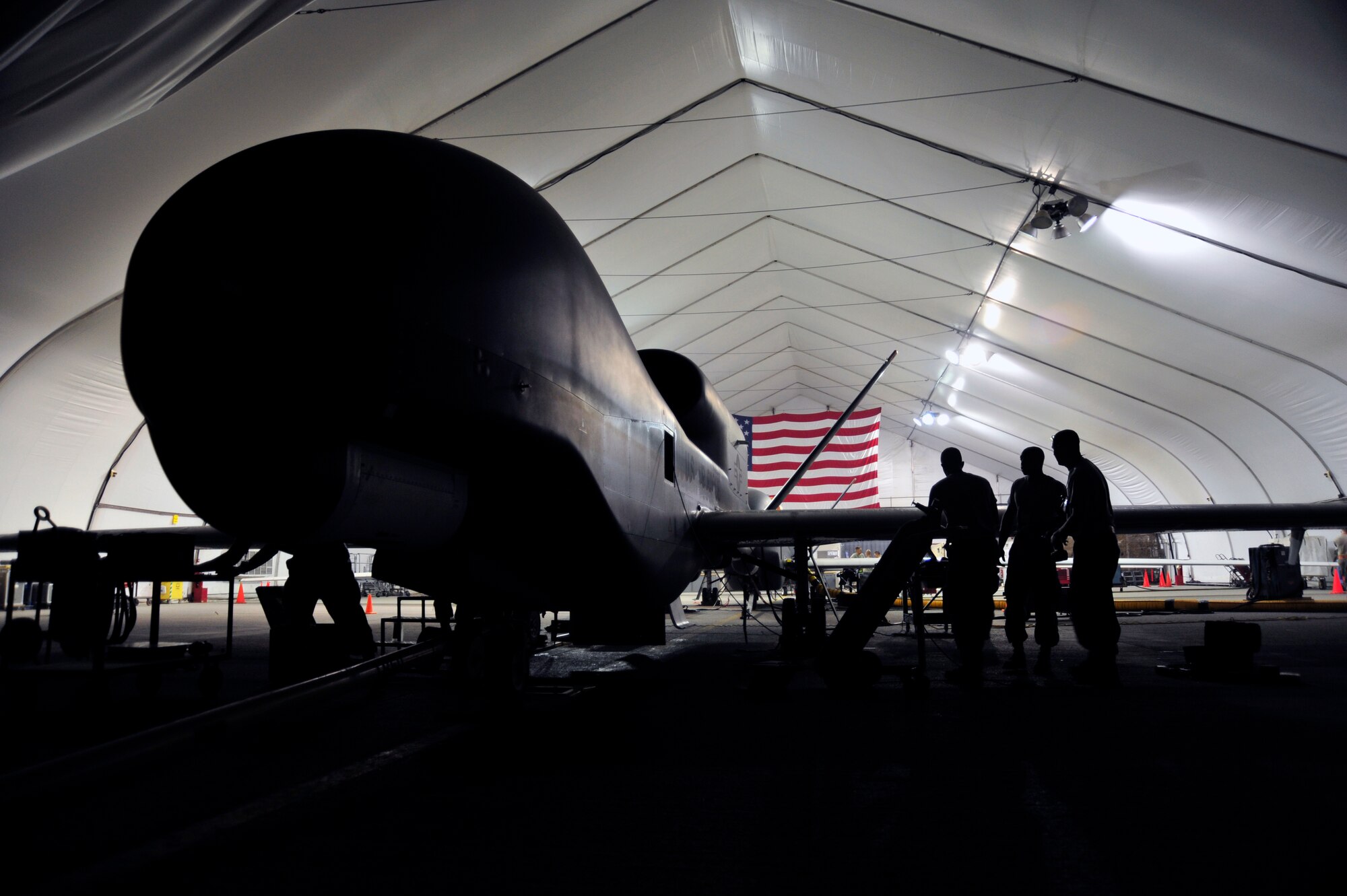 SOUTHWEST ASIA -Airmen of the 380th Expeditionary Aircraft Maintenance Squadron perform basic post-flight inspections and maintenance on an RQ-4 Global Hawk Oct. 22, 2009. The Global Hawk aircraft was towed back to the hanger following a mission in support of Operation Enduring Freedom. (U.S. Air Force photo/Tech. Sgt. Charles Larkin Sr)