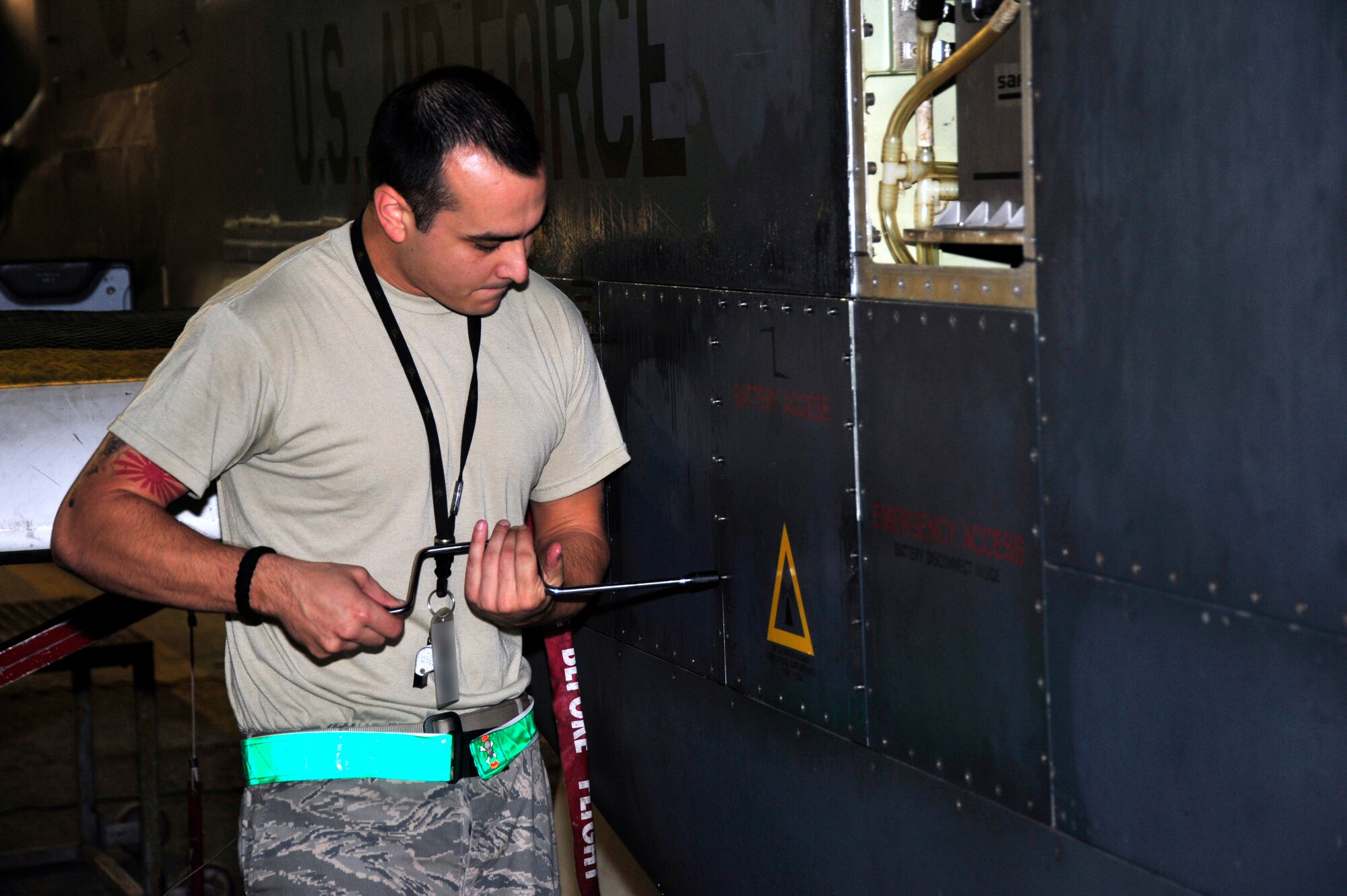SOUTHWEST ASIA -Staff Sgt. Mario Vanore, 380th Expeditionary Aircraft Maintenance Squadron, uses a speed handle to open the battery access panel on an RQ-4 Global Hawk aircraft Oct. 22, 2009. Sergeant Vanore is an electrical and environmental maintenance technician deployed from Beale Air Force Base, Calif., and hails from Clarksville, Tenn. (U.S. Air Force photo/Tech. Sgt. Charles Larkin Sr)