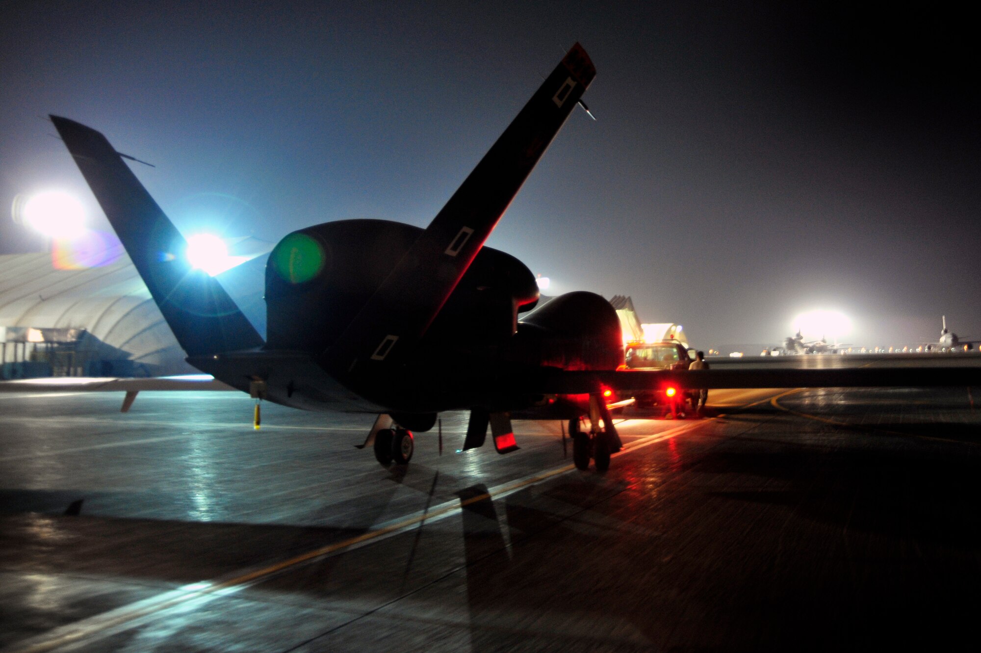 SOUTHWEST ASIA -Airmen of the 380th Expeditionary Aircraft Maintenance Squadron tow an RQ-4 Global Hawk to a hangar Oct. 22, 2009. The Global Hawk aircraft provides intelligence, surveillance and reconnaissance for Operation Enduring Freedom. (U.S. Air Force photo/Tech. Sgt. Charles Larkin Sr)