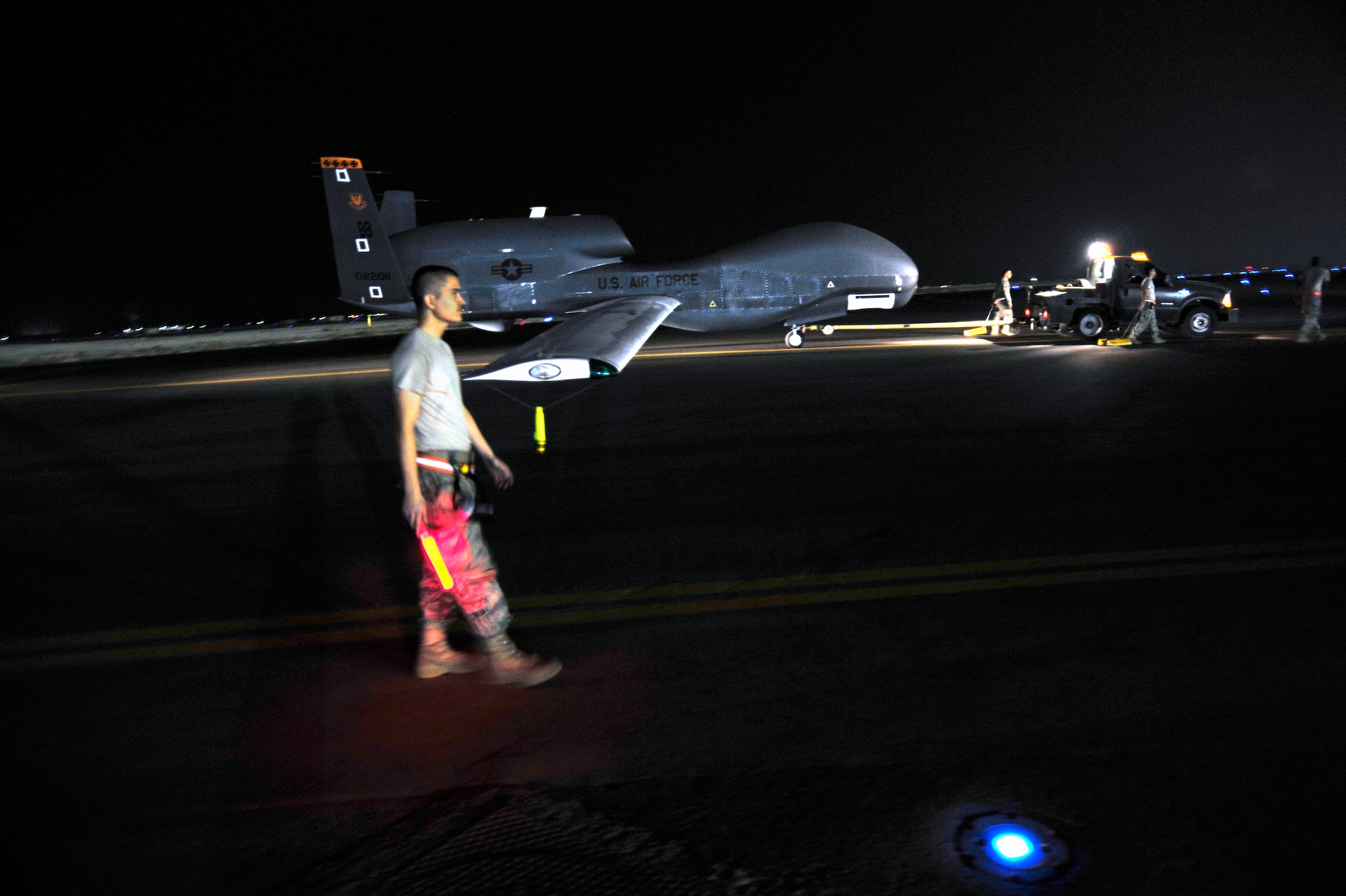 SOUTHWEST ASIA -Airmen of the 380th Expeditionary Aircraft Maintenance Squadron tow an RQ-4 Global Hawk Oct. 22, 2009. The Global Hawk aircraft landed following a mission supporting Operation Enduring Freedom and was relaunched following standard inspections and maintenance. (U.S. Air Force photo/Tech. Sgt. Charles Larkin Sr)