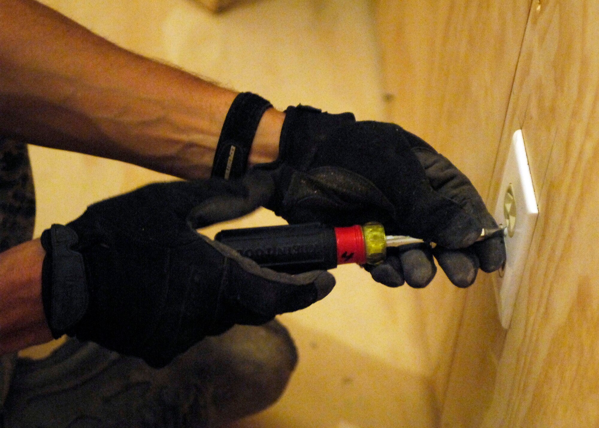 BAGRAM AIRFIELD, Afghanistan -- Tech. Sgt. Sean O'Brien, an electrician from the 455th Expeditionary Civil Engineer Squadron, attaches an electrical outlet cover, Oct. 24, 2009.  After the 455th ECES builds a new facility the electricians must lay all of the wires to provide power.  Sergeant O'Brien is deployed from the Nevada Air National Guard's 152nd CES and hails from Reno, Nev.  (U.S. Air Force photo/Senior Airman Felicia Juenke)