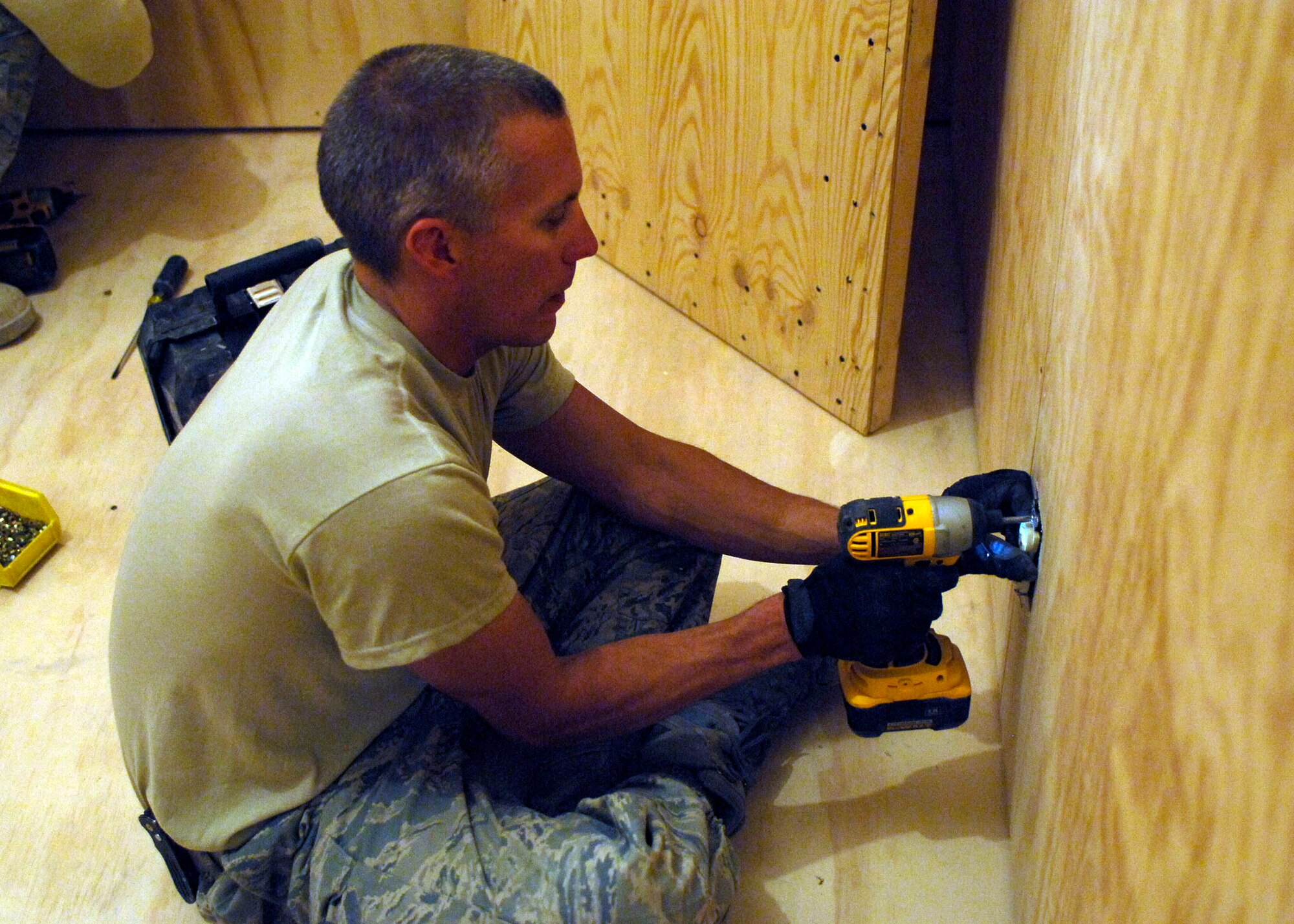 BAGRAM AIRFIELD, Afghanistan -- Tech. Sgt. Sean O'Brien, an electrician from the 455th Expeditionary Civil Engineer Squadron, attaches spacers to an electrical outlet, Oct. 24, 2009.  The spacers allow Sergeant O'Brien to attach an electrical outlet cover.  After the 455th ECES builds a new facility the electricians must lay all of the wires to provide power.  Sergeant O'Brien is deployed from the Nevada Air National Guard's 152nd CES and hails from Reno, Nev.  (U.S. Air Force photo/Senior Airman Felicia Juenke)