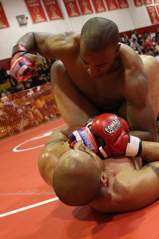 Darnell Mason (top), a middleweight Fight Club 29 member, punishes his opponent with a barrage of body strikes during the U.S. National Pankration Championships in Santa Ana, Calif., Oct. 25. Mason fought his way through several more challengers to claim the bronze for his weight class.