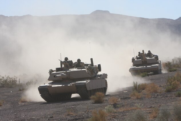 Two tanks with Company D, 1st Tank Battalion, proceed to their next mission on Oct. 25, at the Combat Center during the combined arms exercise known as Steel Knight. The annual exercise was the largest it had ever been this year.