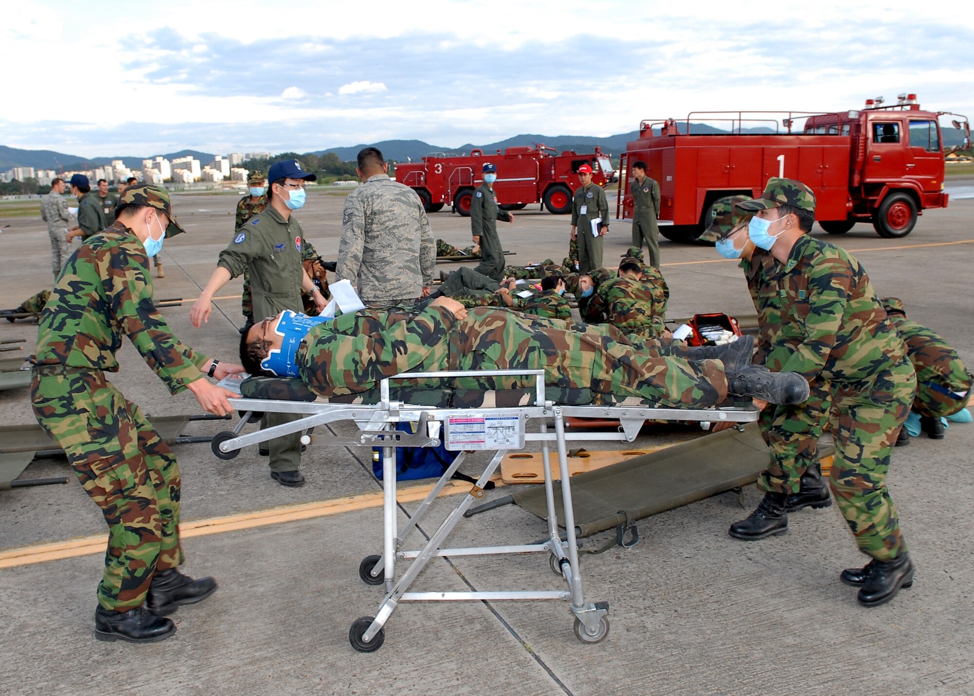 Republic of Korea Air Force and 7th Air Force personnel provide
emergency response support to simulated-injured personnel during an
emergency response exercise Oct. 7 at Seoul Air Base. The exercise prepared
emergency responders for the Seoul Air Show, which was held Oct. 24 and 25. (Courtesy photo)
