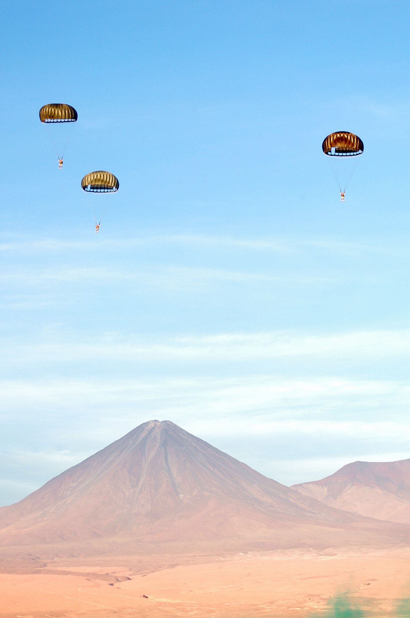 ANTOFAGASTA, Chile -- Pararescue jumpers from the Fuerza Aerea de Chile or FACh descend to their destination in the Atacama Desert in Northern Chile during SALITRE, a multinational exercise focused on interoperability between Chile, the United States, Argentina, Brazil and France. (U.S. Air Force photo)