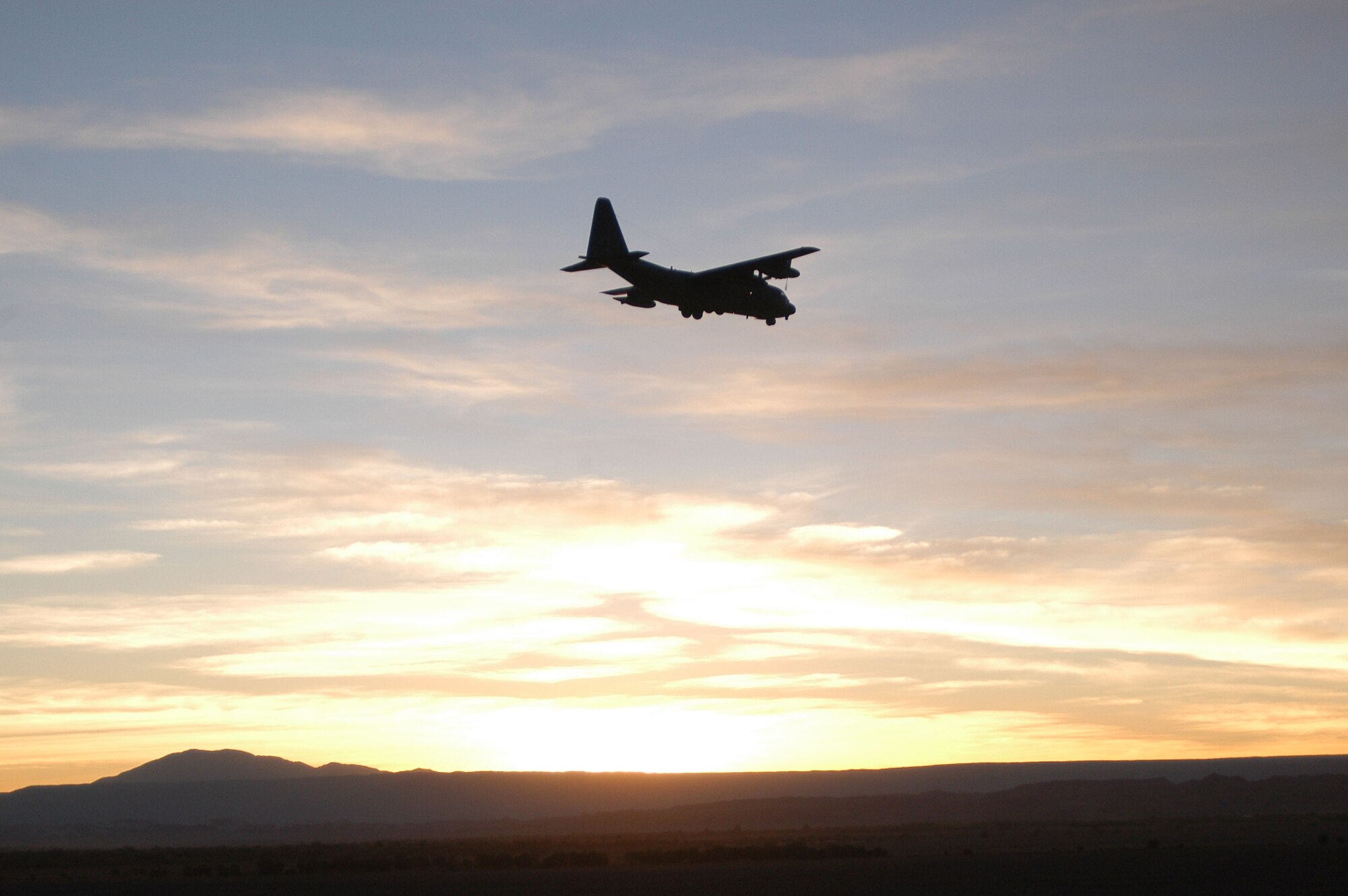 ANTOFAGASTA, Chile -- A U.S. Air Force HC-130 departs a drop zone over the Atacama Desert in Northern Chile during SALITRE, a multinational exercise focused on interoperability between Chile, the United States, Argentina, Brazil and France. (U.S. Air Force photo)