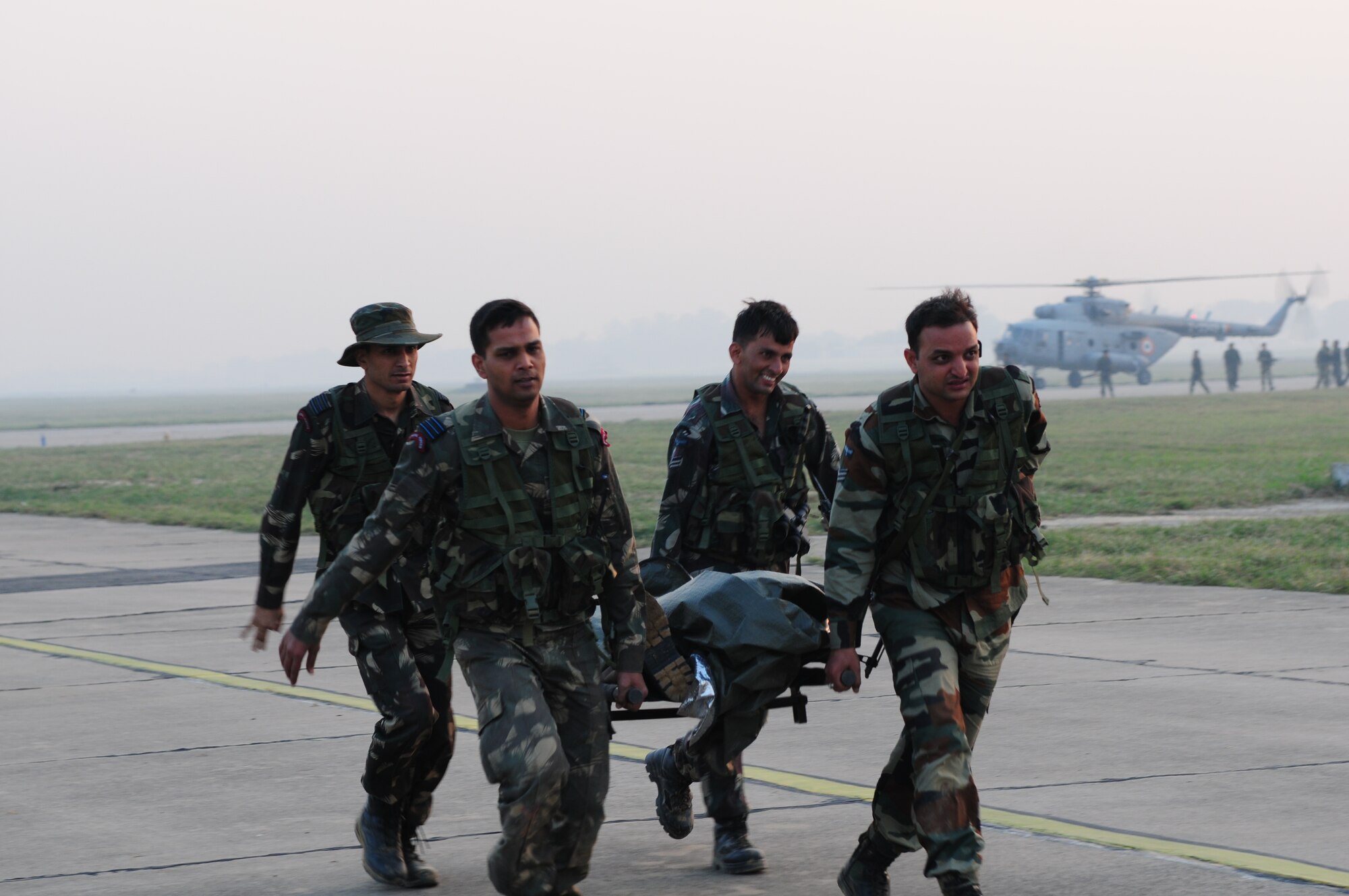 Indian Air Force medics transport a mock patient to a U.S. Air Force C-130 Hercules during a casualty evacuation exercise at Air Force Station Agra, India, Oct. 24. Cope India is a United States and India airlift exercise that provides training for humanitarian assistance and disaster relief operations. (U.S. Air Force photo/Capt. Genieve David)