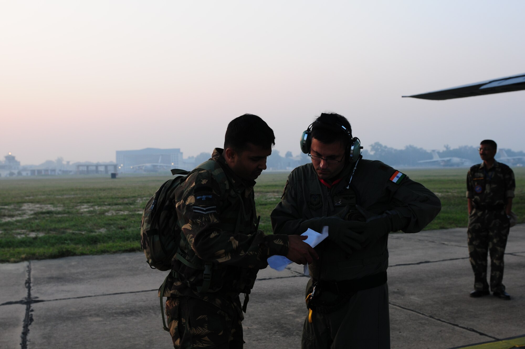 Maj. Scott Cummins, the 353rd Operations Support Squadron medical flight commander at Kadena Air Base, Japan, and a Indian Air Force medic, compare medical reports needed to transport two mock patients during a casualty evacuation exercise at Air Force Station Agra, India, Oct 24. Cope India is a United States and India airlift exercise that provides training for humanitarian assistance and disaster relief operations. (U.S. Air Force photo/Capt. Genieve David)