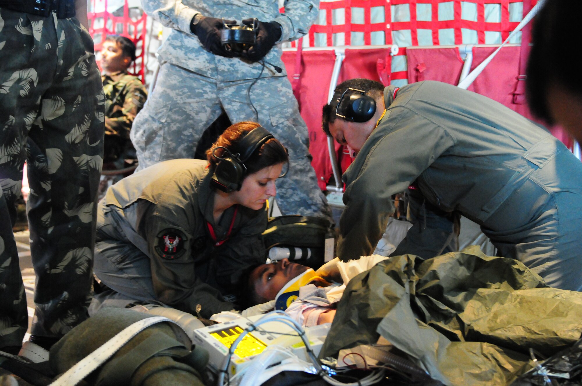 Tech. Sgt. Melissa Worley, an independent duty medical technician from the 353rd Operations Squadron at Kadena Air Base, Japan, and Army Staff Sgt. Peter Biggane, conduct a primary assessment of a victim's injuries during a casualty evacuation exercise at Air Force Station Agra, India. Cope India is a United States and India airlift exercise that provides training for humanitarian assistance and disaster relief operations. (U.S. Air Force photo/Capt. Genieve David)