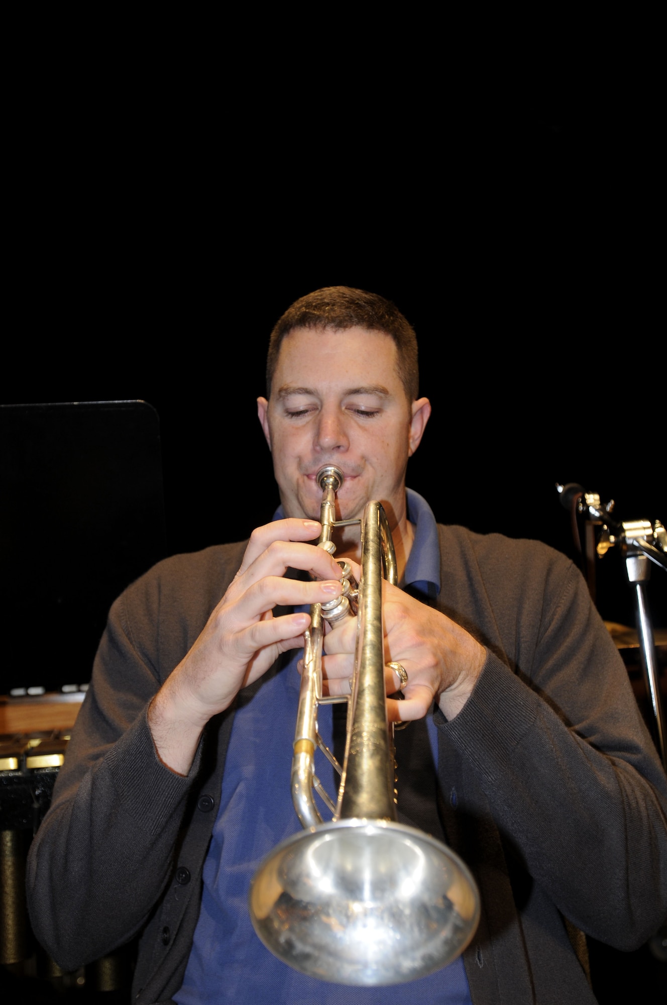 NOWY SACZ, Poland – Staff Sgt. Shane Kibbey warms up on his trumpet prior to a sound check here at the Malopolskie Centrum Kultury Sokol Oct. 22.  Sergeant Kibbey is part of the 41-piece U.S. Air Forces in Europe’s Concert Band playing six concerts in six days, Oct. 20-25, to commemorate 90 years of Polish-American cooperation as part of Gen. Roger Brady’s, USAFE commander, international relations program in partnership with the U.S. State Department.  (U.S. Air Force photo/Master Sgt. Kelley J. Stewart)