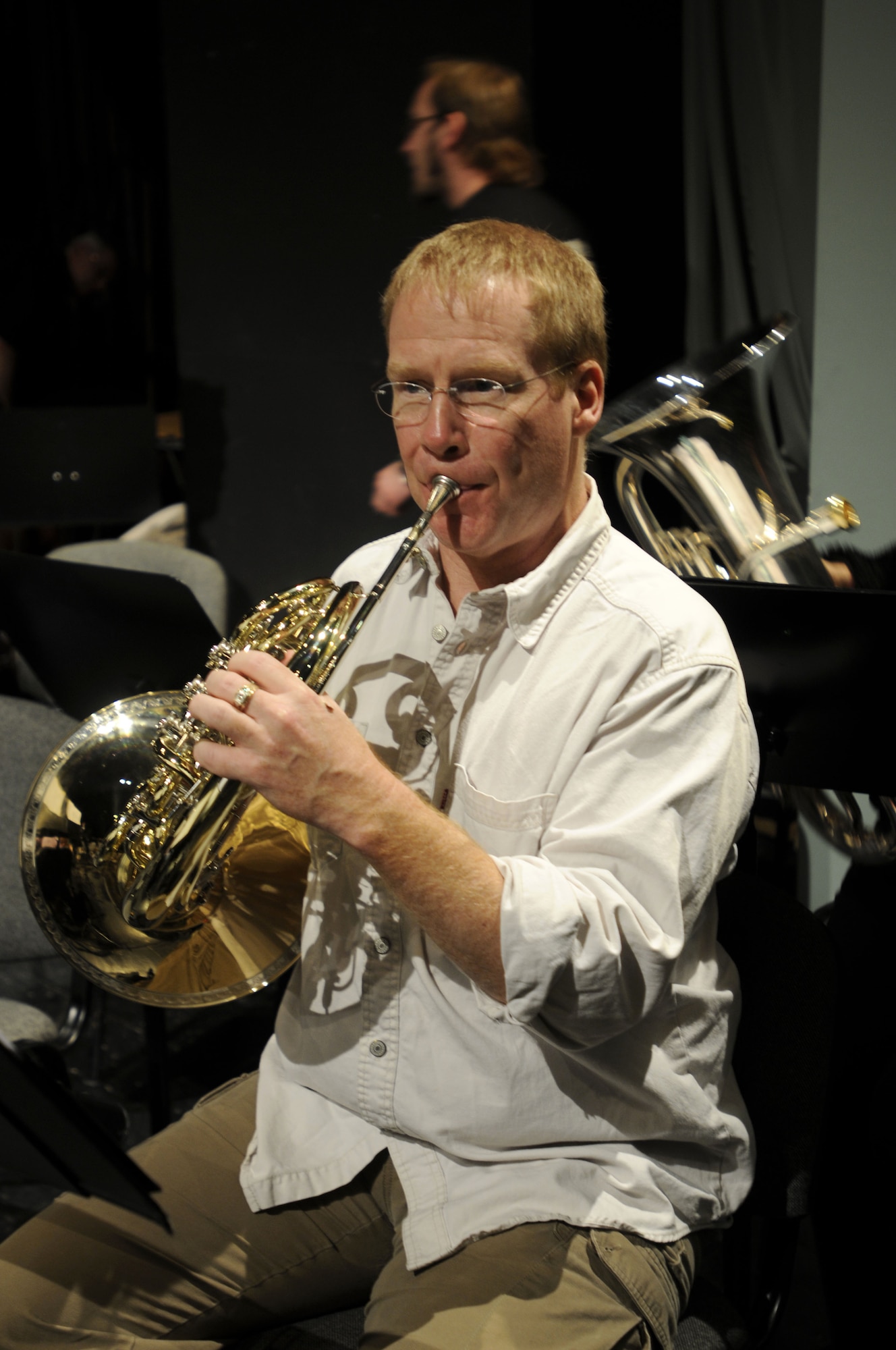 NOWY SACZ, Poland – Tech. Sgt. Steven Schaughency, horn player, warms up prior to a rehearsal here at the Malopolskie Centrum Kultury Sokol Oct. 22.  Sergeant Schaughency is part of the 41-piece U.S. Air Forces in Europe’s Concert Band playing six concerts in six days, Oct. 20-25, to commemorate 90 years of Polish-American cooperation as part of Gen. Roger Brady’s, USAFE commander, international relations program in partnership with the U.S. State Department.  (U.S. Air Force photo/Master Sgt. Kelley J. Stewart)