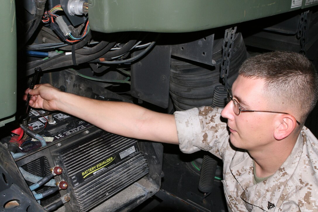 Corporal Jason Rex, a modifications noncommissioned officer with Combat Logistics Company 23, makes repairs to a street sweeper Monday. Along with taking care of its primary mission aboard the Air Station, CLC-23 Marines also volunteer throughout the Lowcountry area for schools and for Marine Corps Community Services functions.
