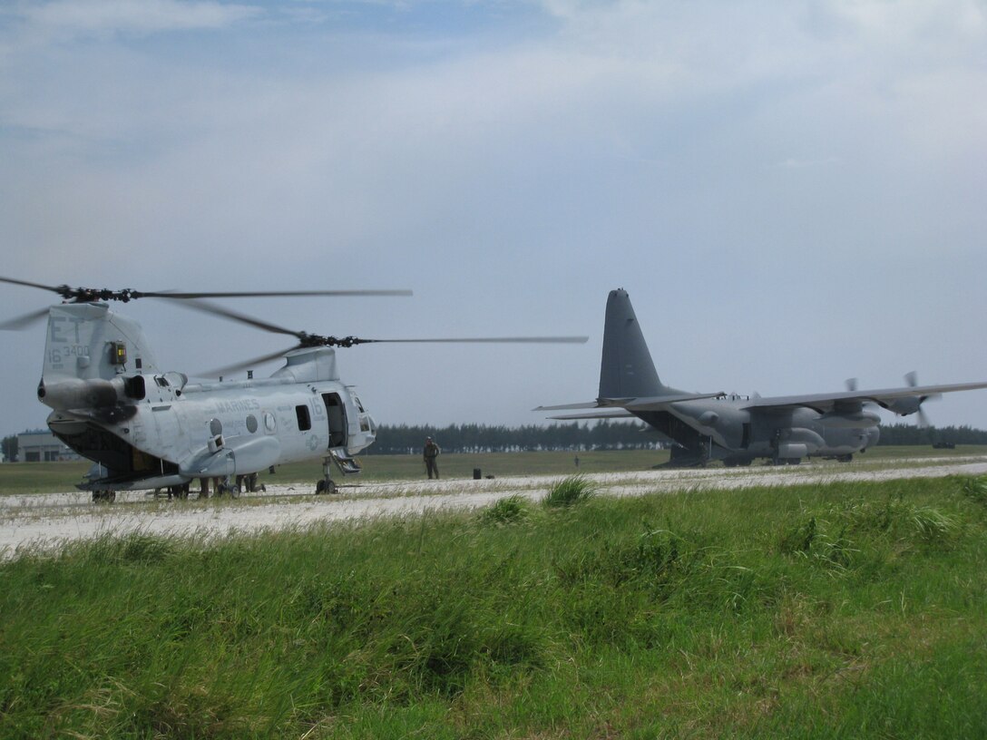 IE SHIMA, Japan -- Forward area refueling point specialists and loadmasters from the 353rd Special Operations Group prepare to transfer fuel from a 1st Special Operations Squadron MC-130H Combat Talon II to CH-46 Sea Knight assigned to Marine Medium Helicopter Squadron 262, the aviation combat element of the 31st Marine Expeditionary Unit here Aug. 8, 2008. FARP specialists and loadmasters utilize a forward area manifold cart to transfer fuel from one aircraft to another in hostile and austere environments. (Courtesy photo)