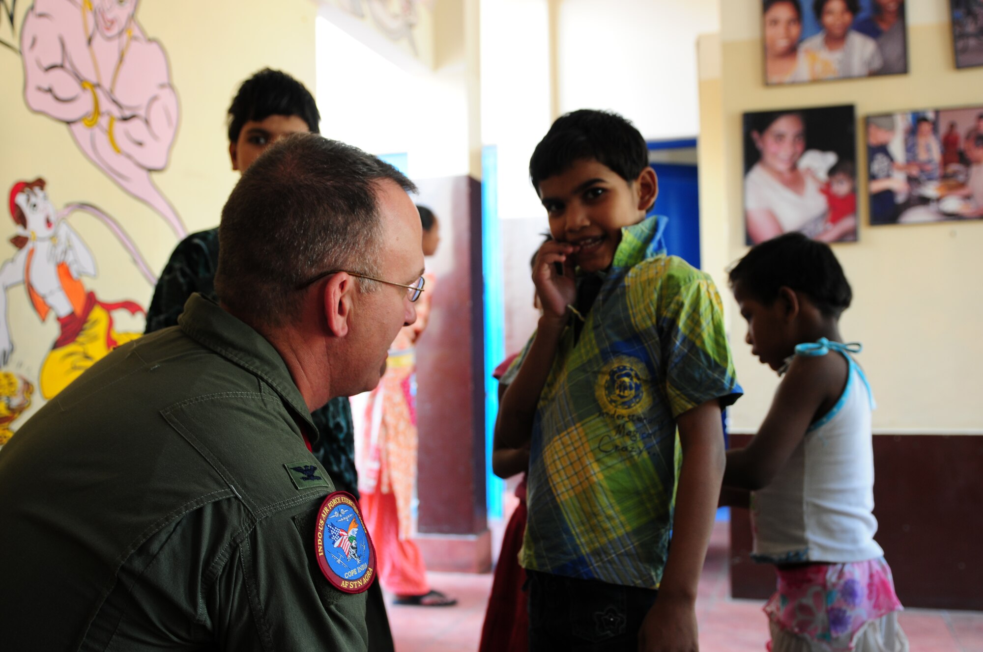 Col. Raymond LaMarche, director of Plans, Programs and Requirements at 13th Air Force, Hickam Air Force Base, Hawaii, visits the Mother Teresa orphanage in Agra, India, during Cope India, Oct 22. More than 150 Airmen and Soldiers volunteered their time with children and the elderly and donated cash, school supplies, food, and clothing during their visit. Cope India is a United States and India airlift exercise that provides training for humanitarian assistance and disaster relief operations. (U.S. Air Force photo/Capt. Genieve David)