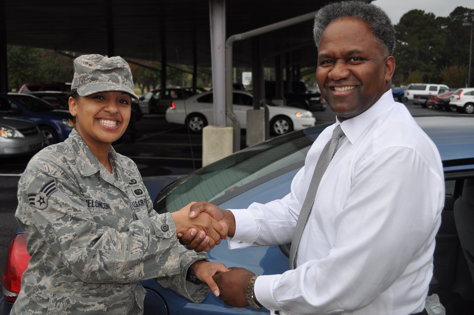 Mr. "HL" Larry presents SrA Charleda Meloncon, 14th Operations Support Squadron, with his coin Thursday, Oct. 22 at Columbus Air Force Base, Miss.  Meloncon received the coin after the Airman focus group and mentoring session with Mr. Larry for her outstanding attitude. (U.S.Air Force Photo/Sonic Johnson)