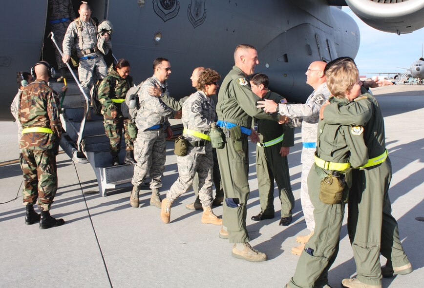 TRAVIS AIR FORCE BASE, Calif. -- Team Travis members formed a reception line to welcome back both 349th AMW and 60th AMW members after completing the Operational Readiness Inspection. The members flew off to the Air National Guard base at Alpena, Mich. Oct. 17 to perform their missions under wartime conditions during the ORI. (U.S. Air Force photo/Master Sgt. Robert Wade)
