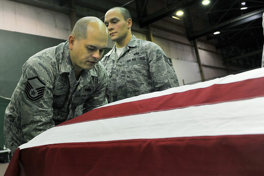 Master Sgt. David Schmidt, Offutt Air Force Base honor guard, Neb. prepares to lift a casket during a training session at Offutt Oct. 21. United States Air Force Honor Guard trainers visited the Nebraska base to evaluate and help sharpen the skills of base honor guard members. (U.S. Air Force photo by Charles Haymond) 
