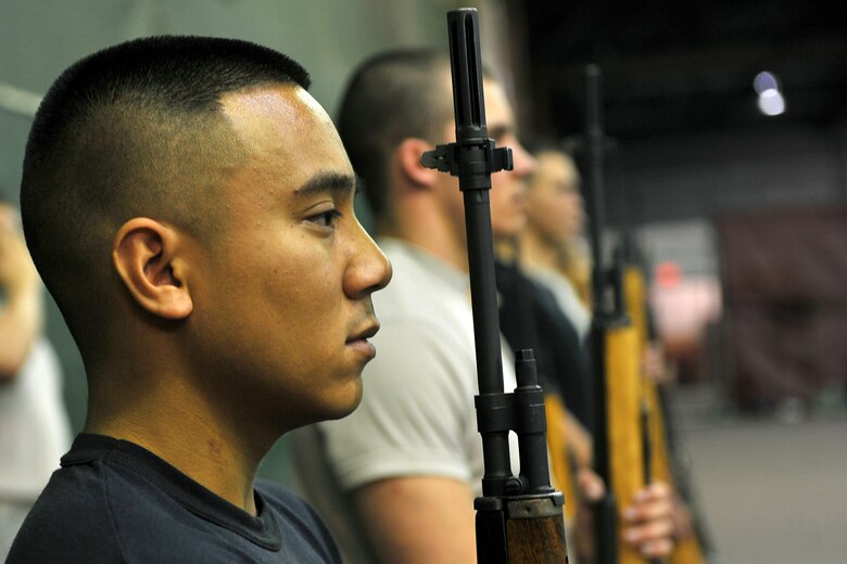 OFFUTT AIR FORCE BASE, Neb., -- Airman 1st Class Janjorrell Abad, 55th Communications Squadron, stands at attention during a simulated 21-gun salute during an Air Force Honor Guard training session at the Martin Bomber Building here Oct. 21. The Air Force Honor Guard visited Offutt to evaluate and help sharpen the skills of Offutt's Honor Guard members, as well as honor guard members from numerous installations. U.S. Air Force Photo by Charles Haymond