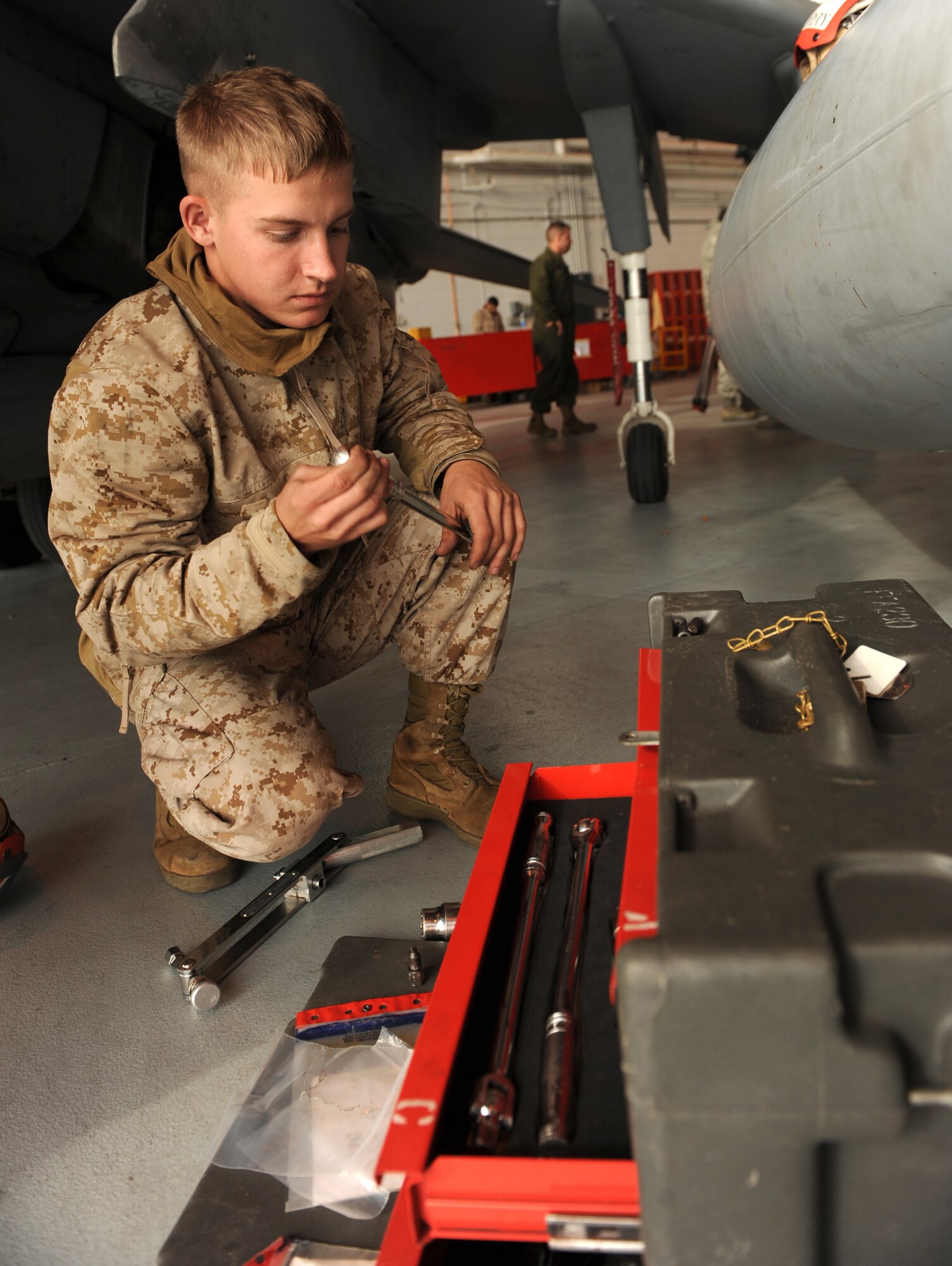 Cpl. Jason Fowler, a Marine Attack Squadron 542 ordnance technician from Cherry Point, N.C., takes a wrench from a tool box to fix a fuel leak on an AV-8B Harrier II Oct. 21, 2009, during the Mountain Roundup exercise at Mountain Home Air Force Base, Idaho. Mountain Roundup is a large-force exercise running from Oct. 15 through Oct. 30 and includes participants from the German air force, U.S. Air Force, U.S. Navy and U.S. Marines. (U.S. Air Force photo/Airman 1st Class Debbie Lockhart)