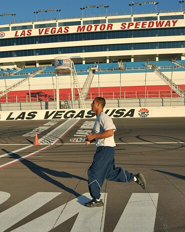 LAS VEGAS -- Staff Sgt. Josh Line, 99th Civil Engineering Squadron heat, ventilation and air conditioning craftsman, crosses the finish line after completing a 1.5 mile run at the Las Vegas Motor Speedway, Oct. 26. (U.S. Air Force photo by Airman 1st Class Stephanie Rubi) 